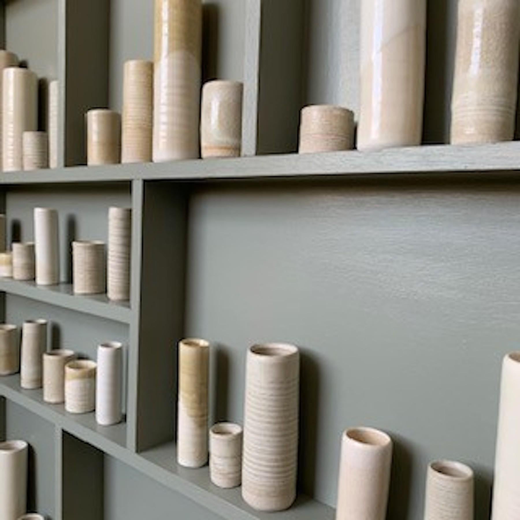 Emma Bell’s ceramic and porcelain Pot Frame – Installation Piece.
Emma Bell says: “This piece is inspired by my glaze test vessels. As a potter, I am always staggered by how different the same/similar glaze turns out on different clay bodies when it