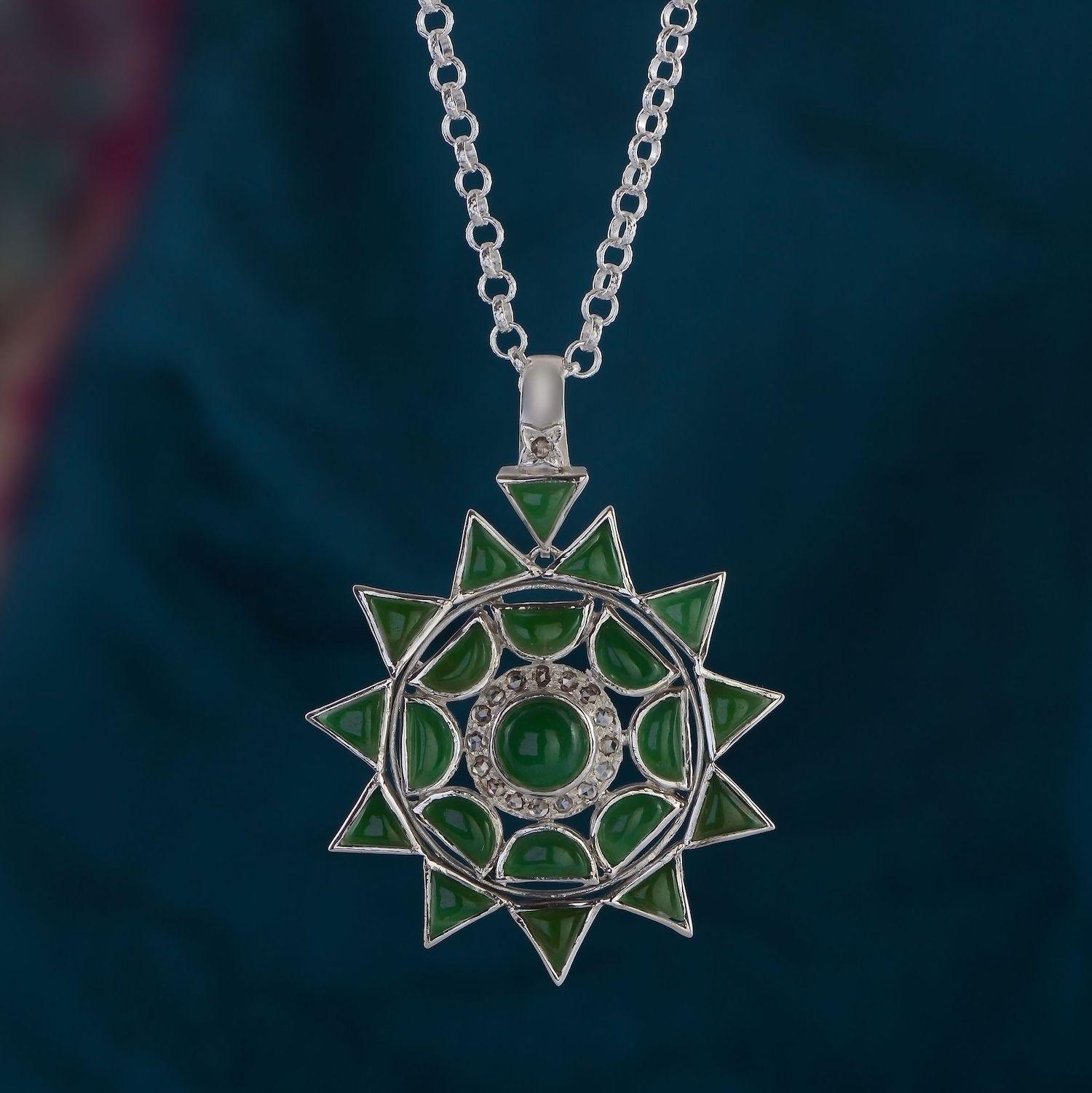 The  Jade Diamond Silver Statement Man's Pendant, has been handmade in our workshops. Made in sterling silver, we have hand cut jade into shapes resembling the sun, moon and stars and embedded it with black diamonds. The pendant comes with a 32 inch