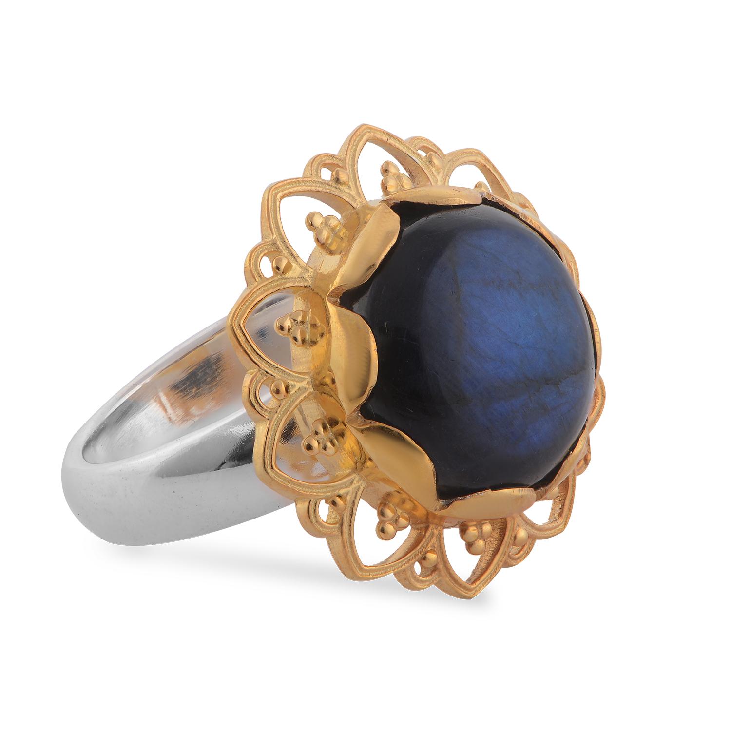 

This lovely Emma Chapman Labradorite Gold Plate Ring, has been handmade in our workshops. It has jaali and embossed work on it and is embedded with labradorite. It is made in sterling silver with 24 karat gold vermeil. The ring has matching