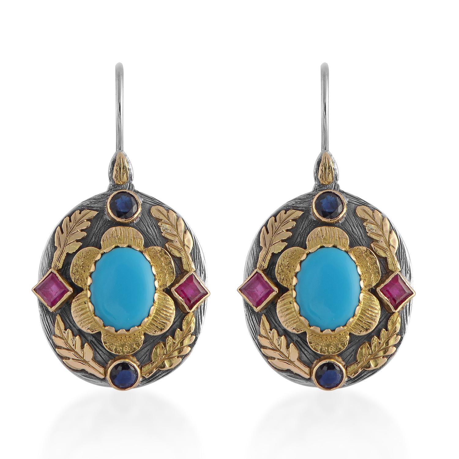 

The Turquoise Ruby Sapphire 18 Karat Gold Silver Dangle Earrings, are one of a kind and have been handmade in our workshops. They are embedded with turquoise which is surrounded by rubies and blue sapphires set in 18kt gold. The base of the
