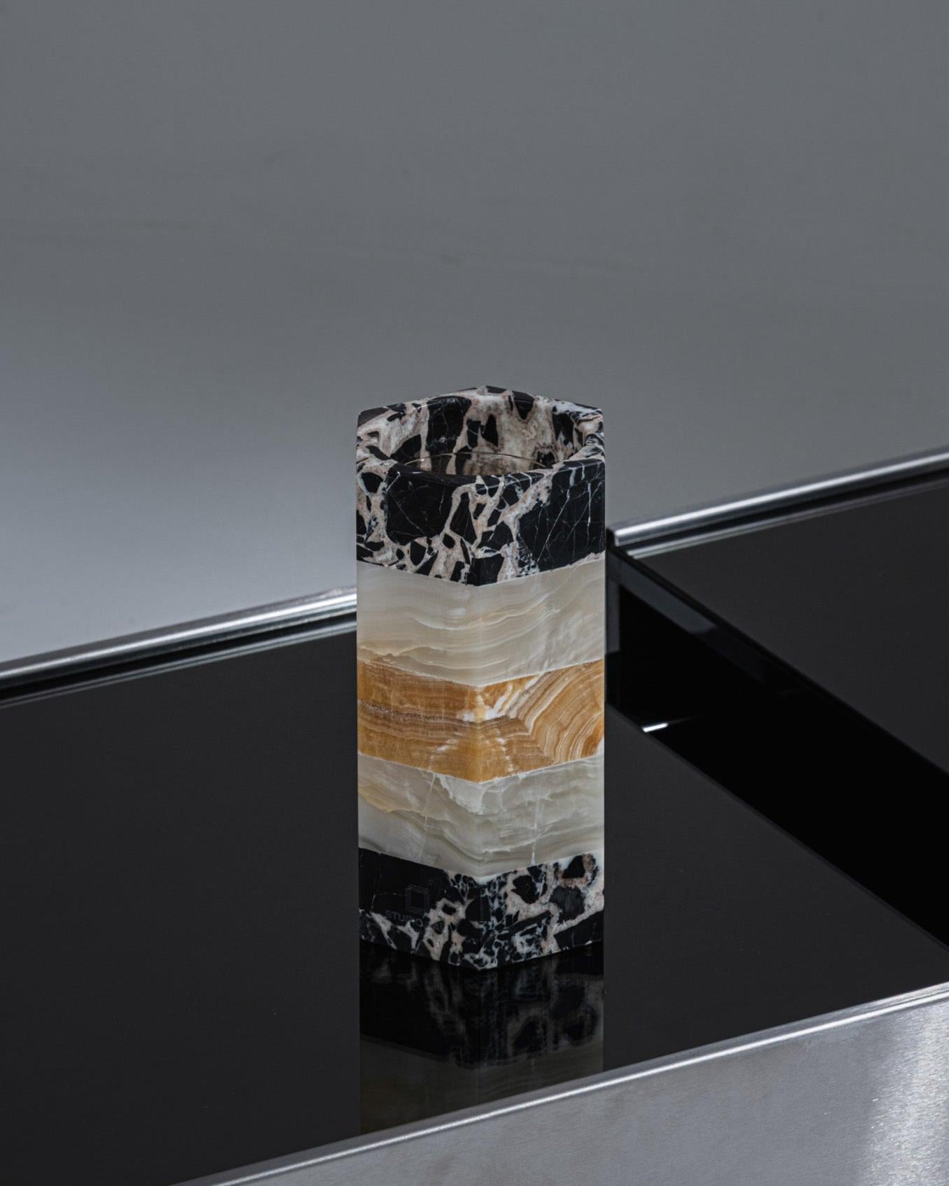 The Emma cachepot is a miniature replica of the famous Gisou table, crafted using the same exceptional materials. Combining Grand Antique marble, white onyx, and veined orange onyx, it brings the architectural power of stone furniture into a refined