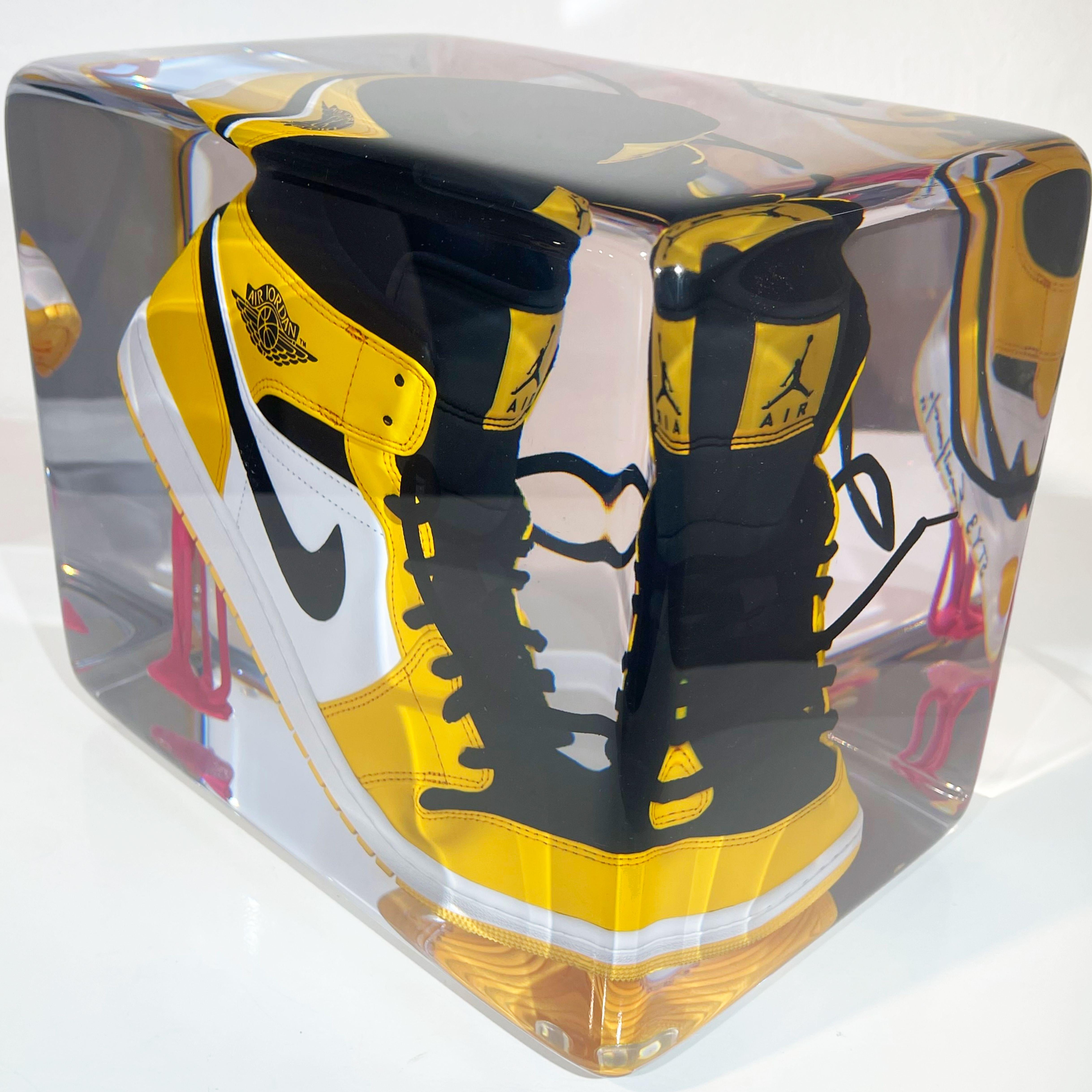 Collection: Perseverancia
Edition: 03/20
Description: Jordan 1 “Taxi Yellow” sneaker with black laces attached to pink
bubblegum, full casted, sanded and polished by hand in transparent
resin.
Size: 20x30cm
Height: 25cm
Weight: 16kg
Year: 2023


The