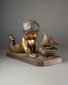 Emmanuel Villanis: Child playing with a boat, Patinated bronze sculpture C. 1900