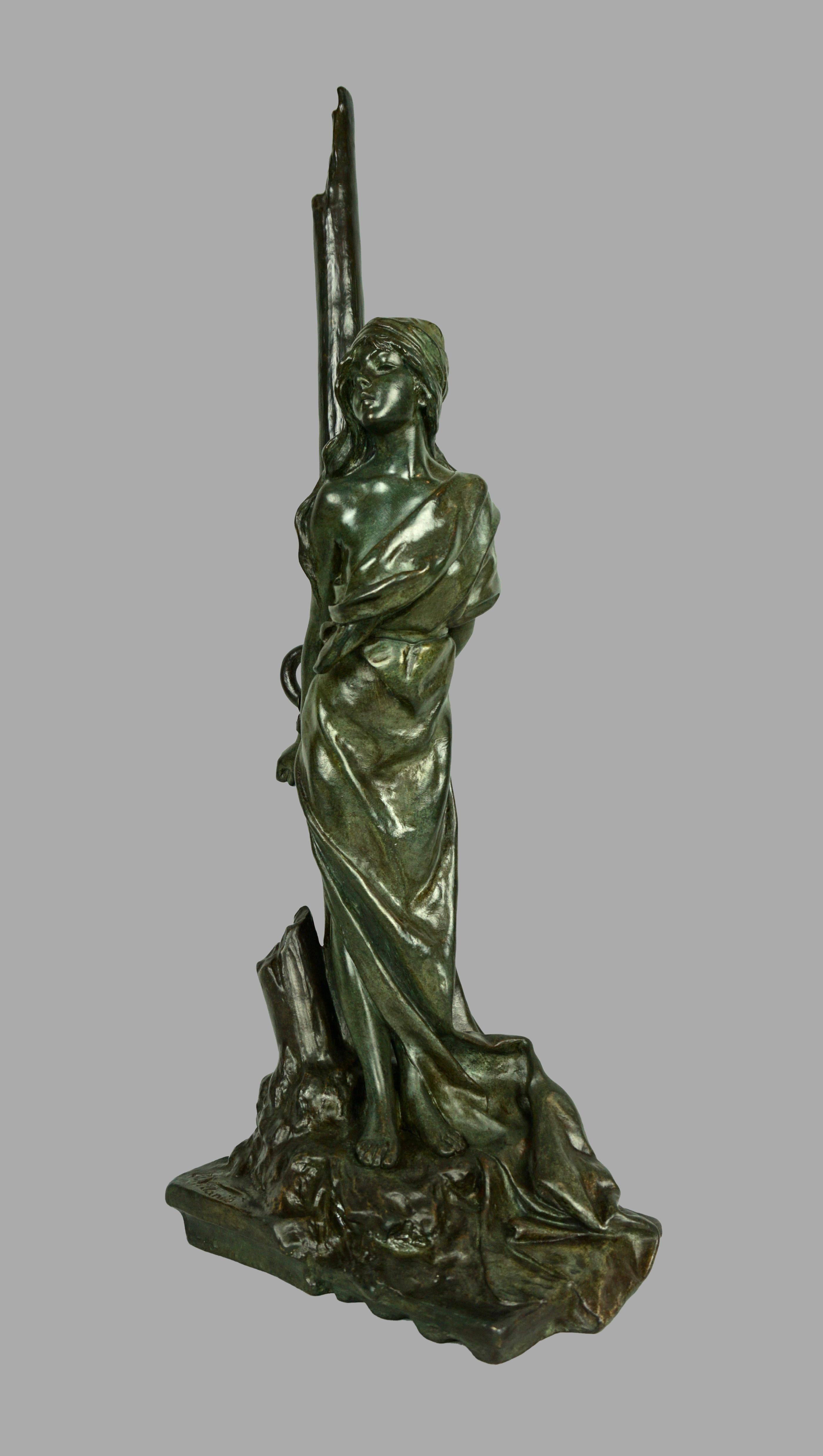 A dramatic bronze model of a woman chained to a stake entitled 
