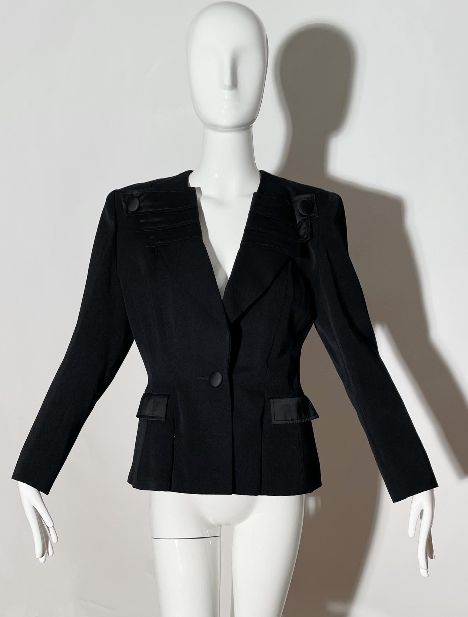 Black blazer with silk lapel. Front pockets. Button details. Cotton blend. Made in France.
*Condition: Excellent vintage condition. No visible Flaws.

Measurements Taken Laying Flat (inches)—
Shoulder to Shoulder: 17 in.
Sleeve Length: 22 in.
Bust: