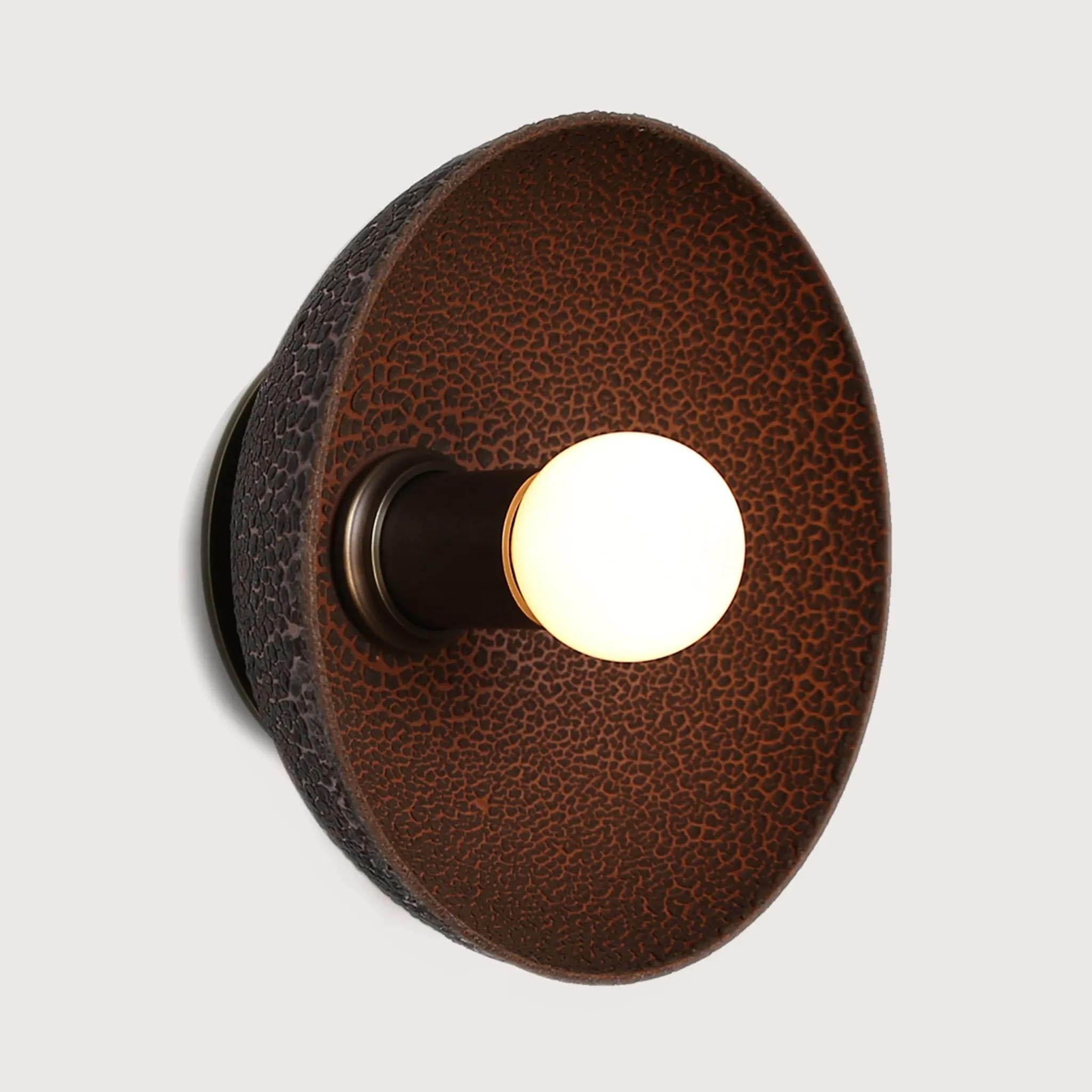 The Emmet sconce, large ADA, is hand-cast terracotta and glazed with either a matte or textured lichen glaze and is made specifically for settings that need to meet ADA standards. The lichen glaze produces a beautiful, organic texture that lets the