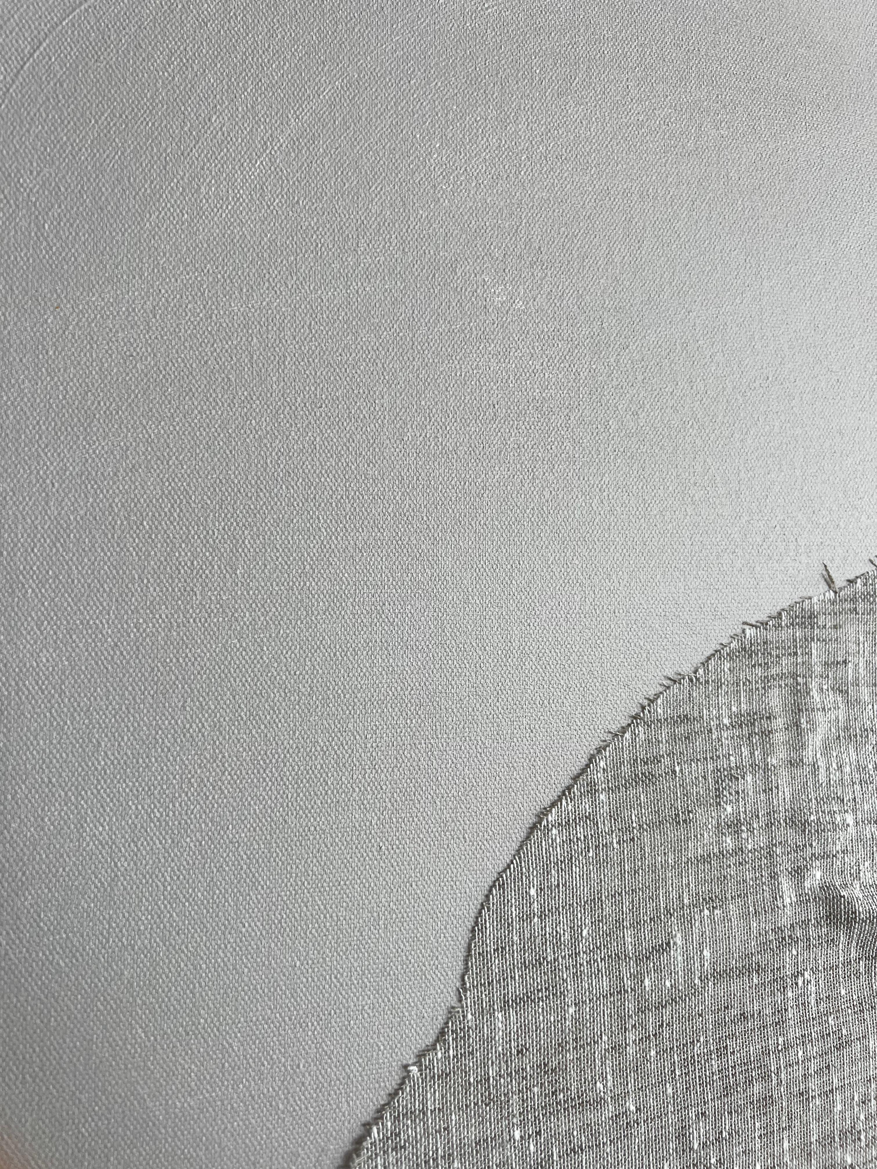 “Fragment of Silence” is a large-scale minimalist work by Finnish multidisciplinary artist Emmi Iida, measuring 100 x 80 cm.

The piece features a soft, arch-like textile form embedded onto a muted gray canvas, evoking both architectural and organic