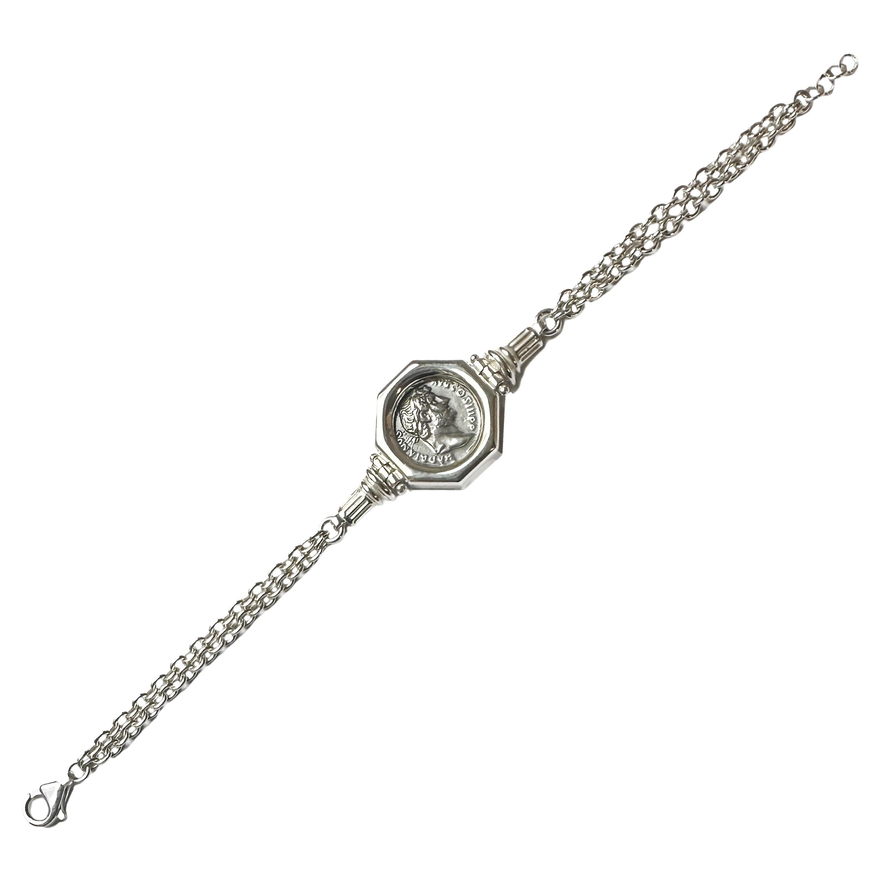 <p>An authentic Roman silver denarius from the 2nd century AD, depicting the Emperor Hadrian, has been set in this sterling silver bracelet, handmade by our goldsmiths. On the side, two graceful columns adorn the coin; on the back of the coin, we