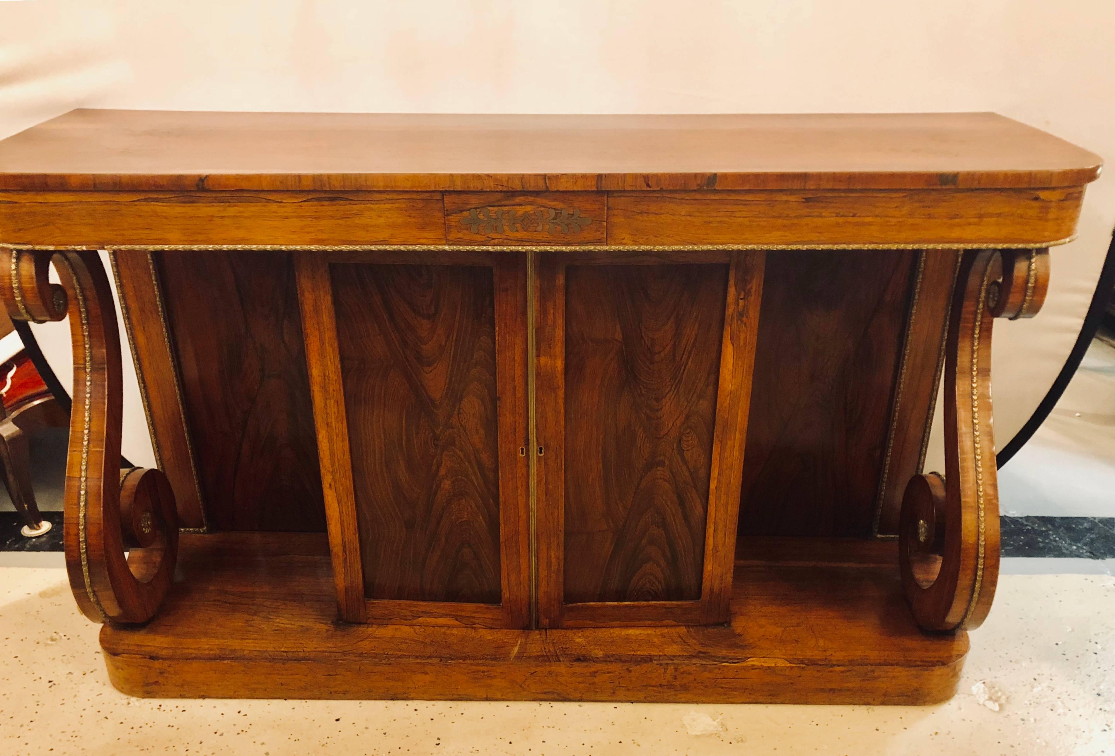 An Empire Boule inlaid rosewood credenza or sideboard. This stunning sideboard or server has a centre boule panel with bronze castings running down the S curved legs and apron as well as the sides. Simply one of the finest antique sideboards one