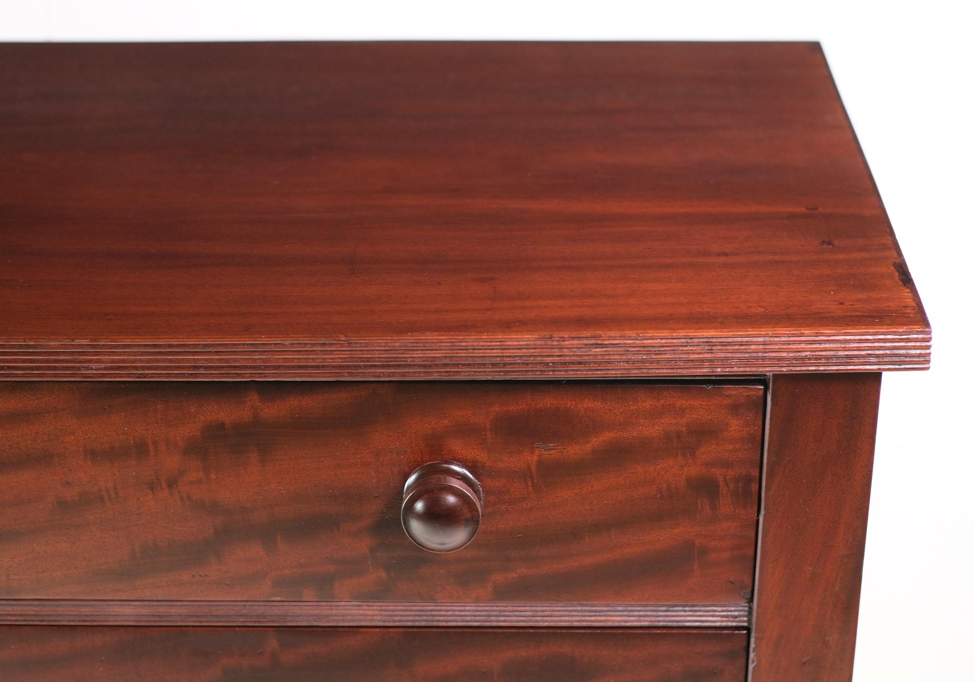 Early 20th Century roomy dark tone mahogany dresser. Features with four drawers with center reinforcements and round wood pulls. Done in an Empire styling. This can be seen at our 333 West 52nd St location in the Theater District West of Manhattan.