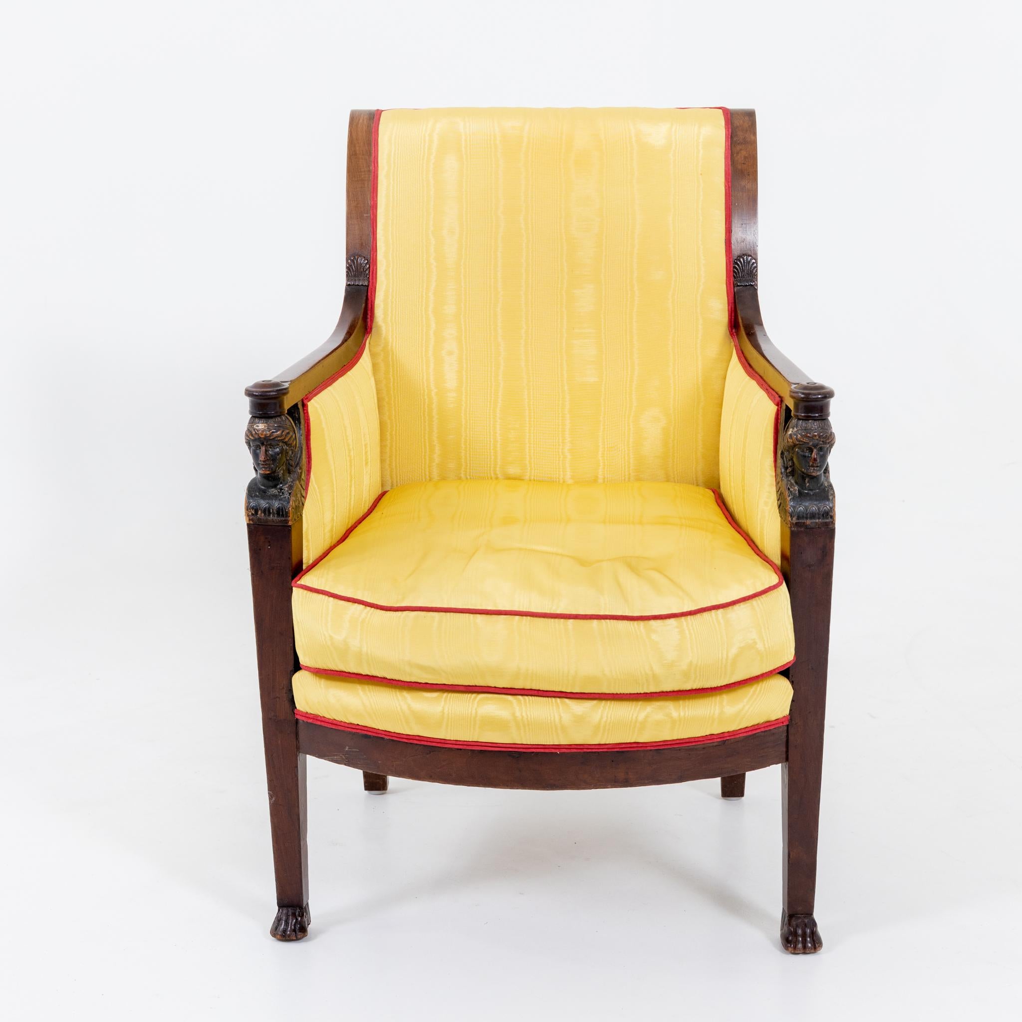 Empire fauteuil in mahogany and yellow silk morée upholstery with red piping and carved winged caryatids, France c. 1800. Lit.: J. Mottheau, Meubles et Emsembles Directoire Empire, Tf. 20.