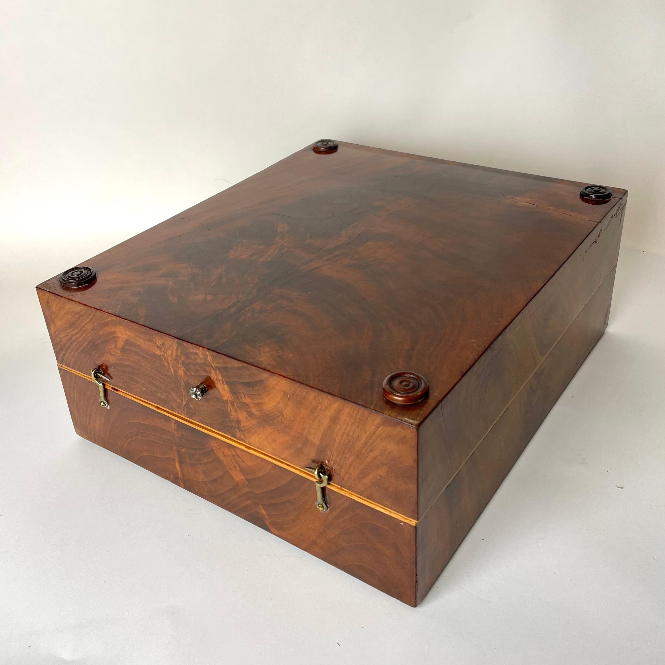 An Elegant Empire Backgammon Game Box in Mahogany (Swietenia Mahogani) with details in Hallmark Silver. Made in the early 19th Century.

This Games Box for Backgammon is the perfect decorative piece that is also complete with pieces for playing the
