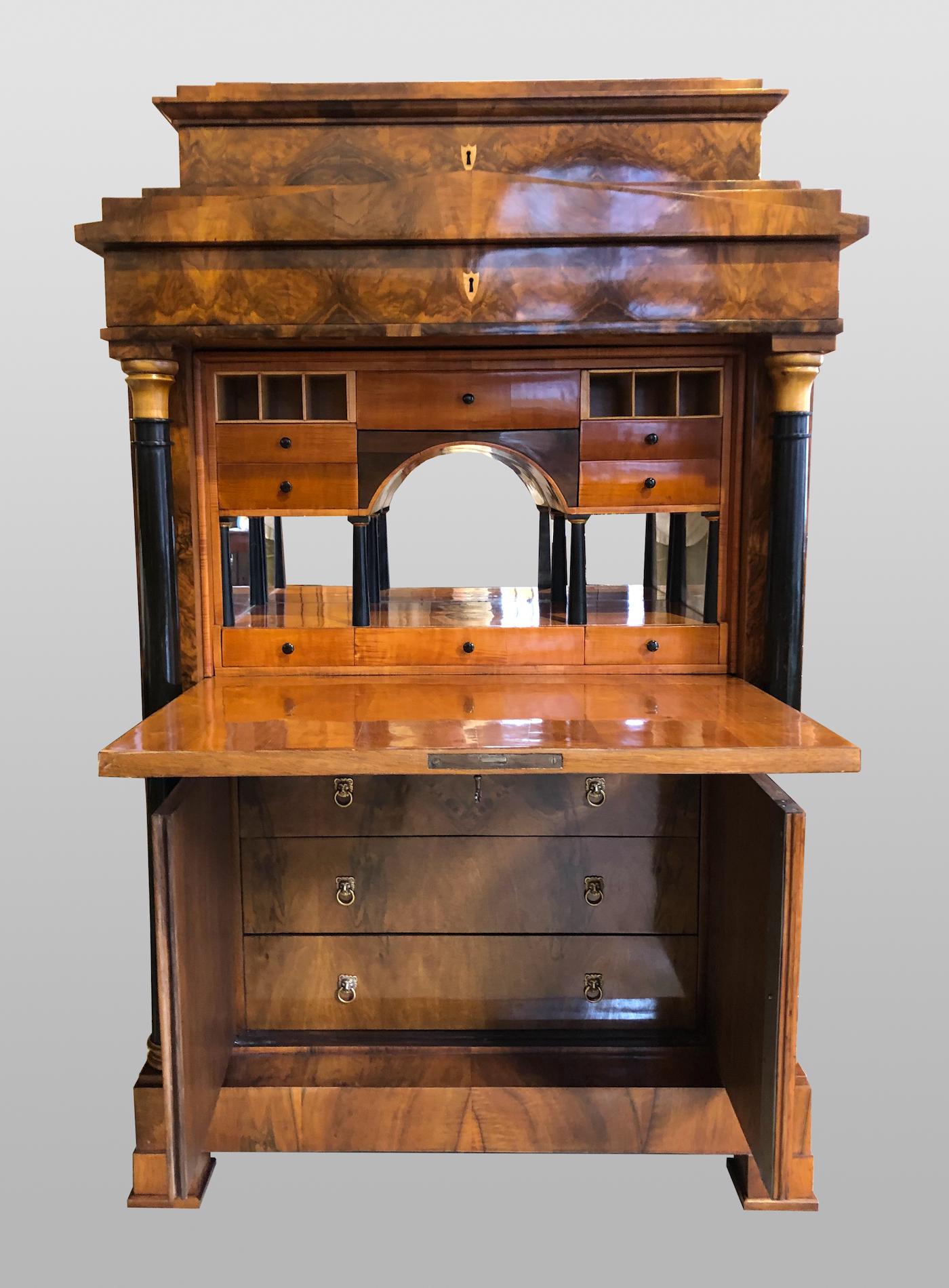 This unique Empire / Biedermeier secretary was created in Mainz around 1820 and is veneered in walnut and partly on oak. Curled maple, pear tree and maple were used in the furnishings. It comes from an estate of a villa in Mainz. But also the