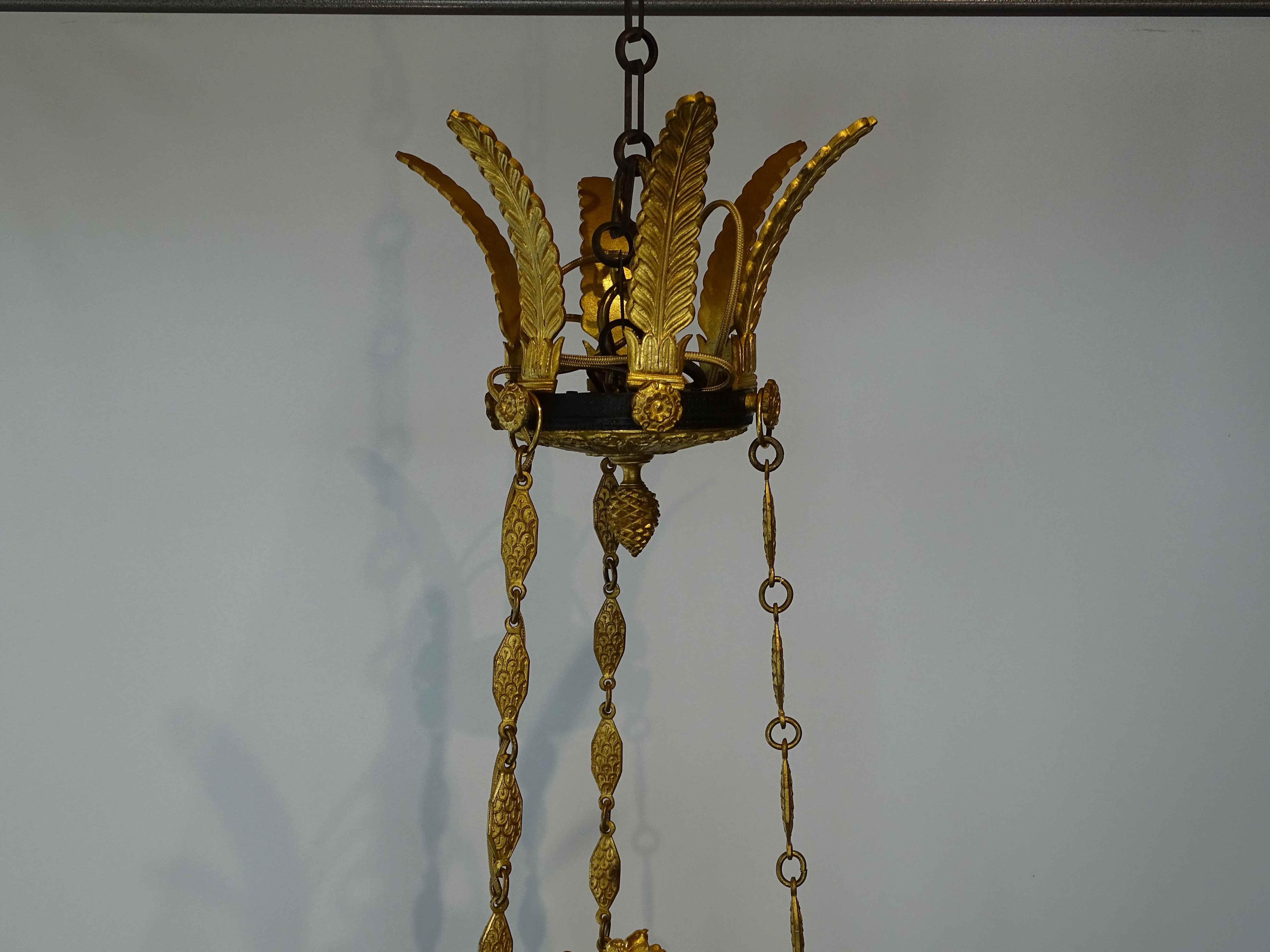 Extremly elegant French Empire 19th century gilt bronze and black patina six light chandelier signed by famous Millet Paris.

The chandelier has a beautiful decor composed of many finely chiselled details with a central winged angel.
It is