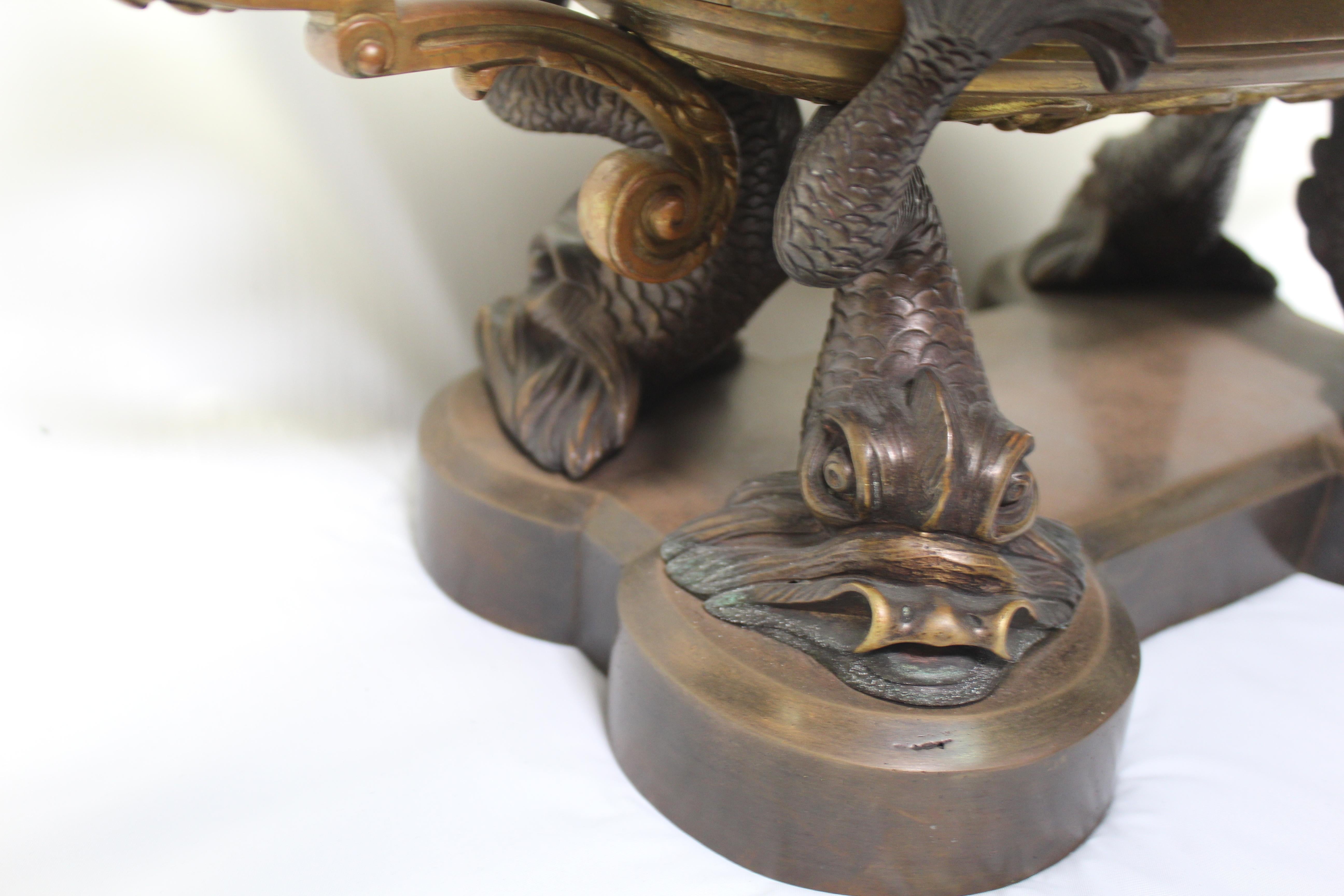 A rare find of this centerpiece bowl in a golden Dore' finish. With two winged nude Angles for handles. All supported by four Dolphins in a bronze patina finish. Still has the Original Bowl insert! I don't think there are any more like it now. A