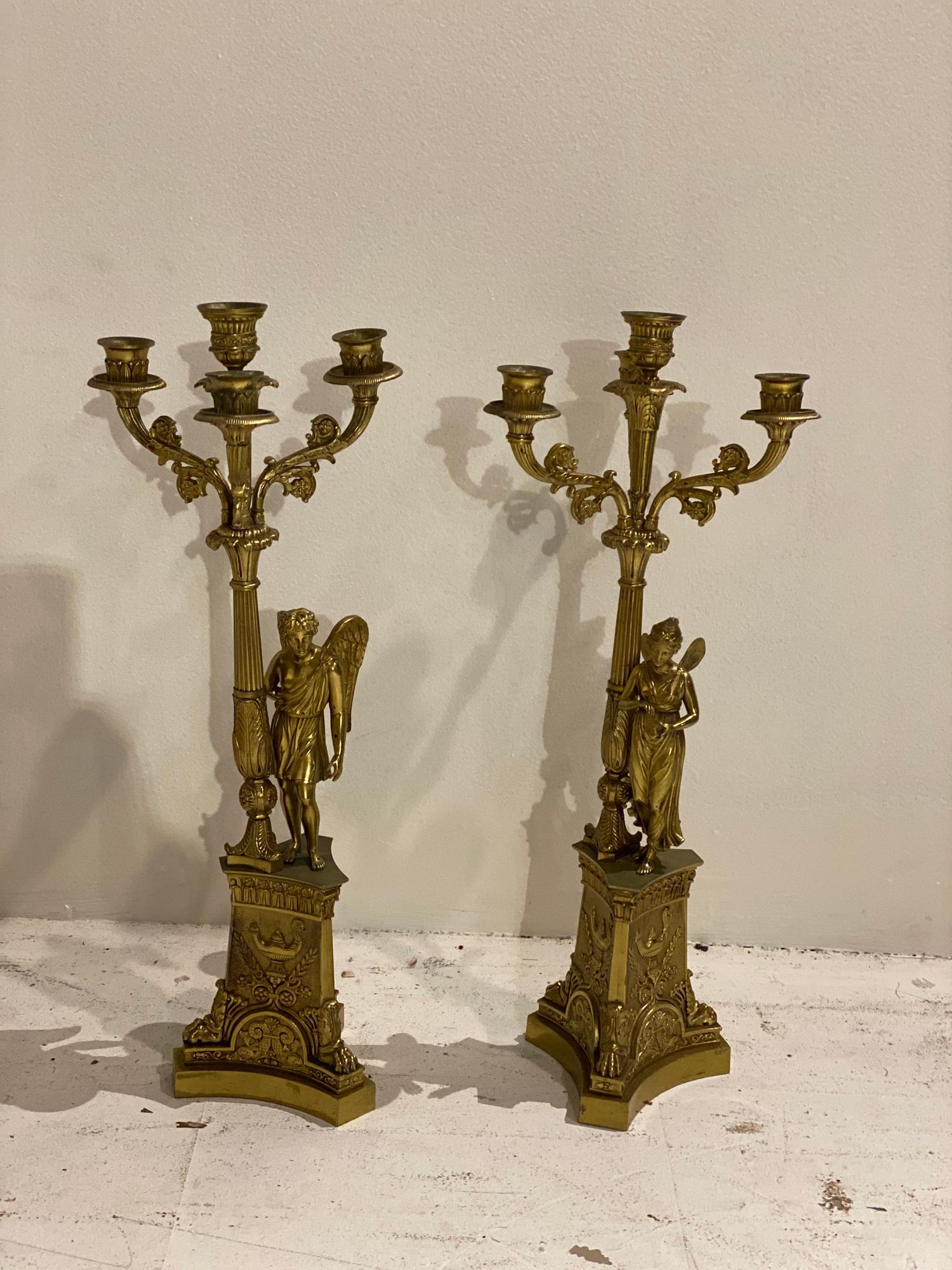 A pair of late 19th century French empire candlesticks with three lights converted into table lamps