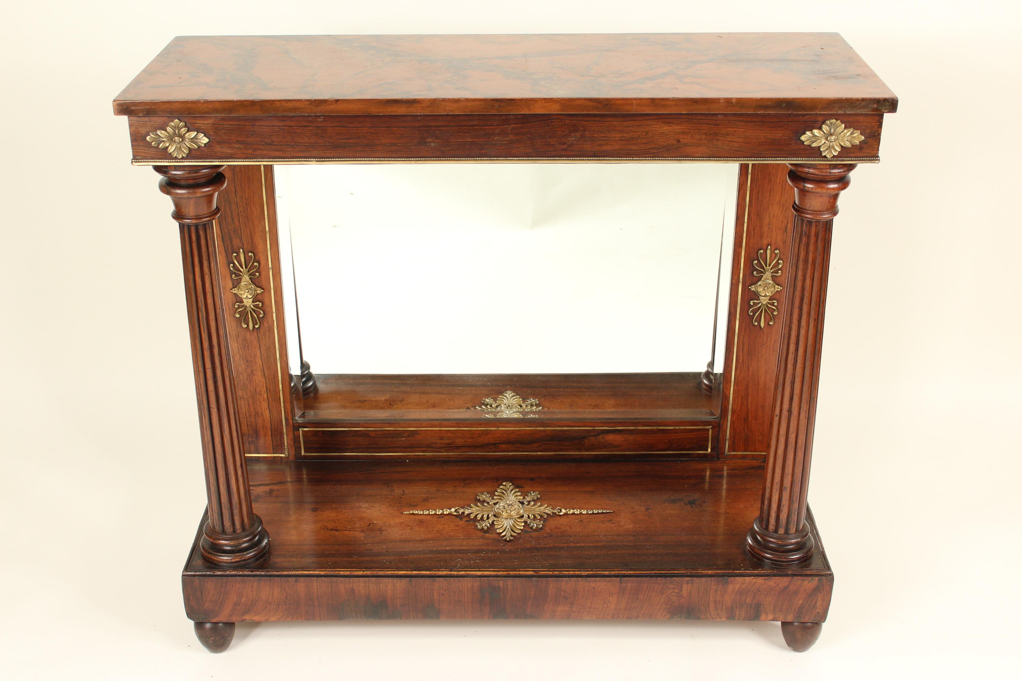 Empire bronze-mounted rosewood console table with a faux marble (wood painted to look like marble) top, circa 1820. This console table has an excellent old deep patina and robust columns. The faux marble top is later.