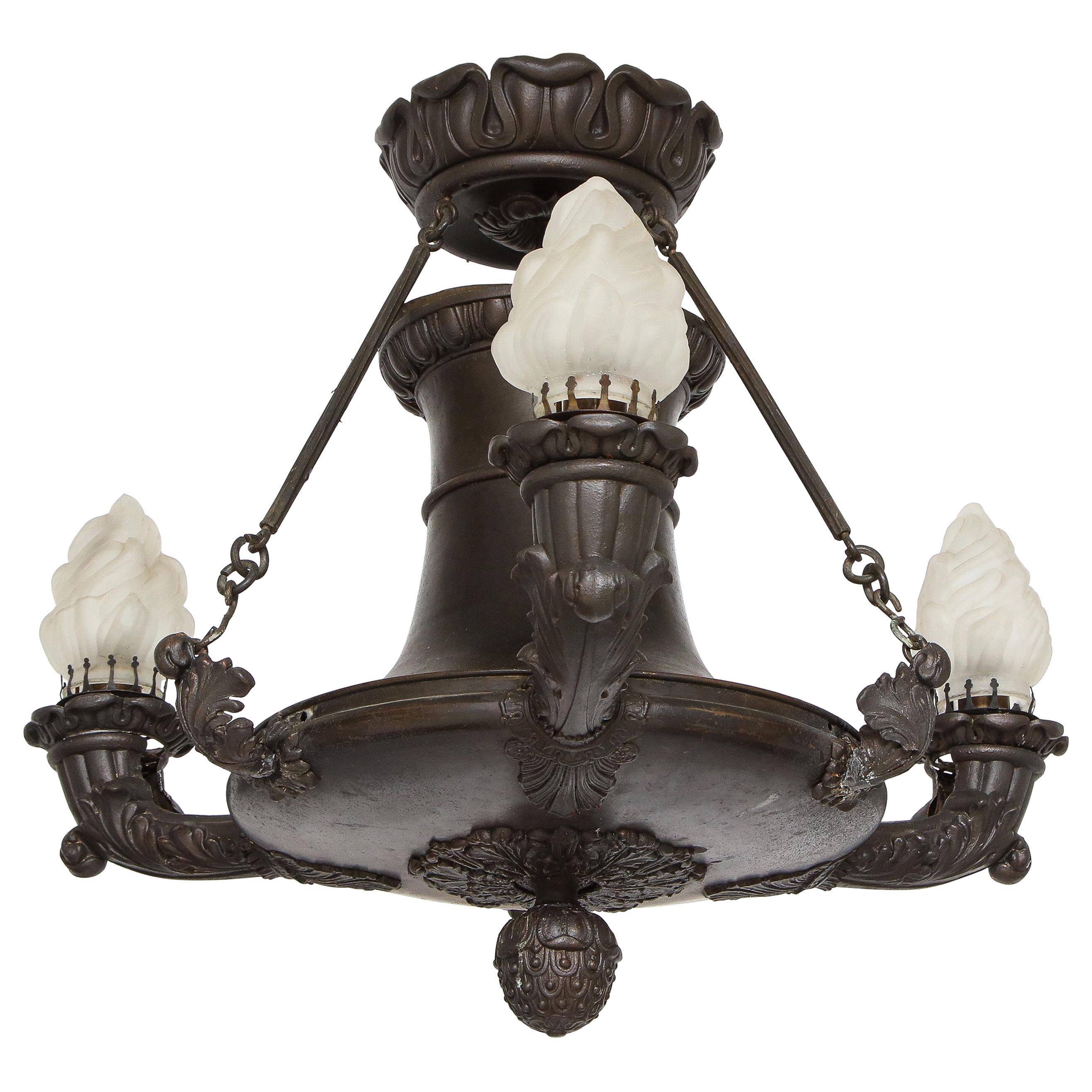 Empire bronze chandelier with three alabaster flame shades.