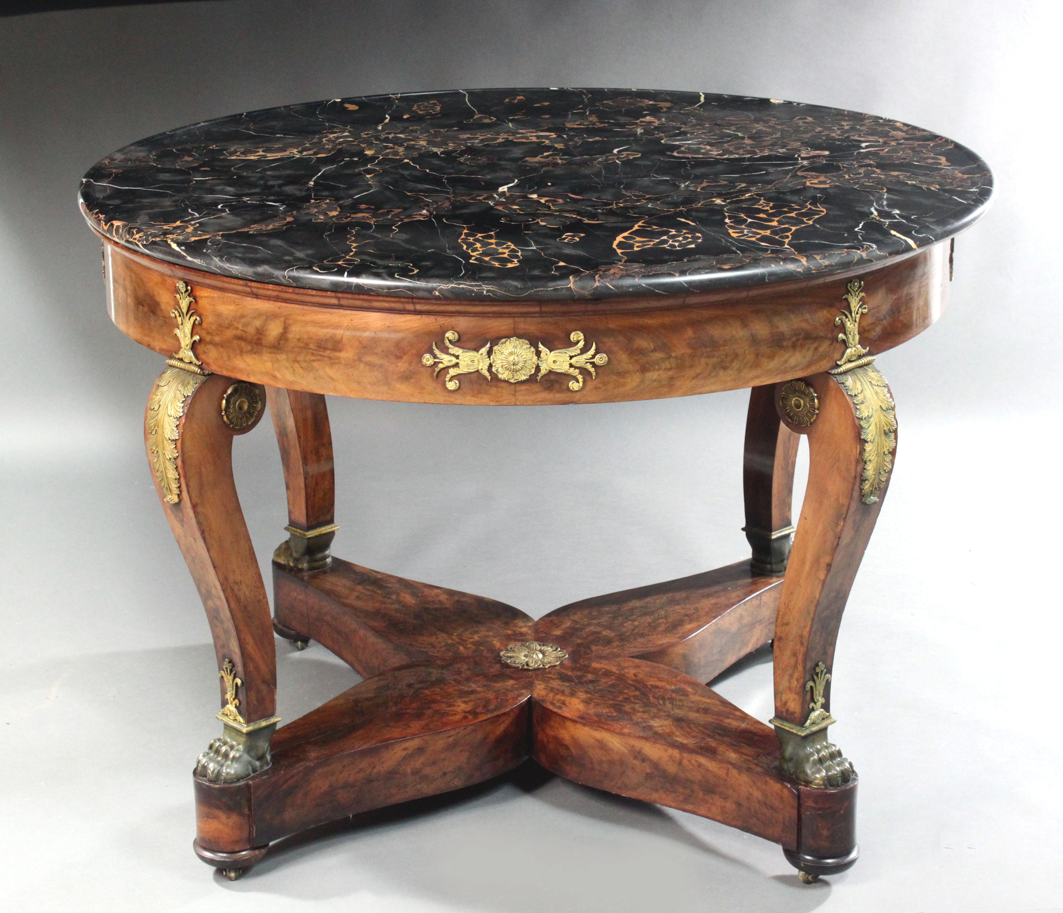 Empire Centre Table
A large French Empire centre table in figured mahogany with ormolu mounts, bronze feet and the original dished yellow-veined dark grey marble top.

This table is both larger and of better quality than most other Empire centre