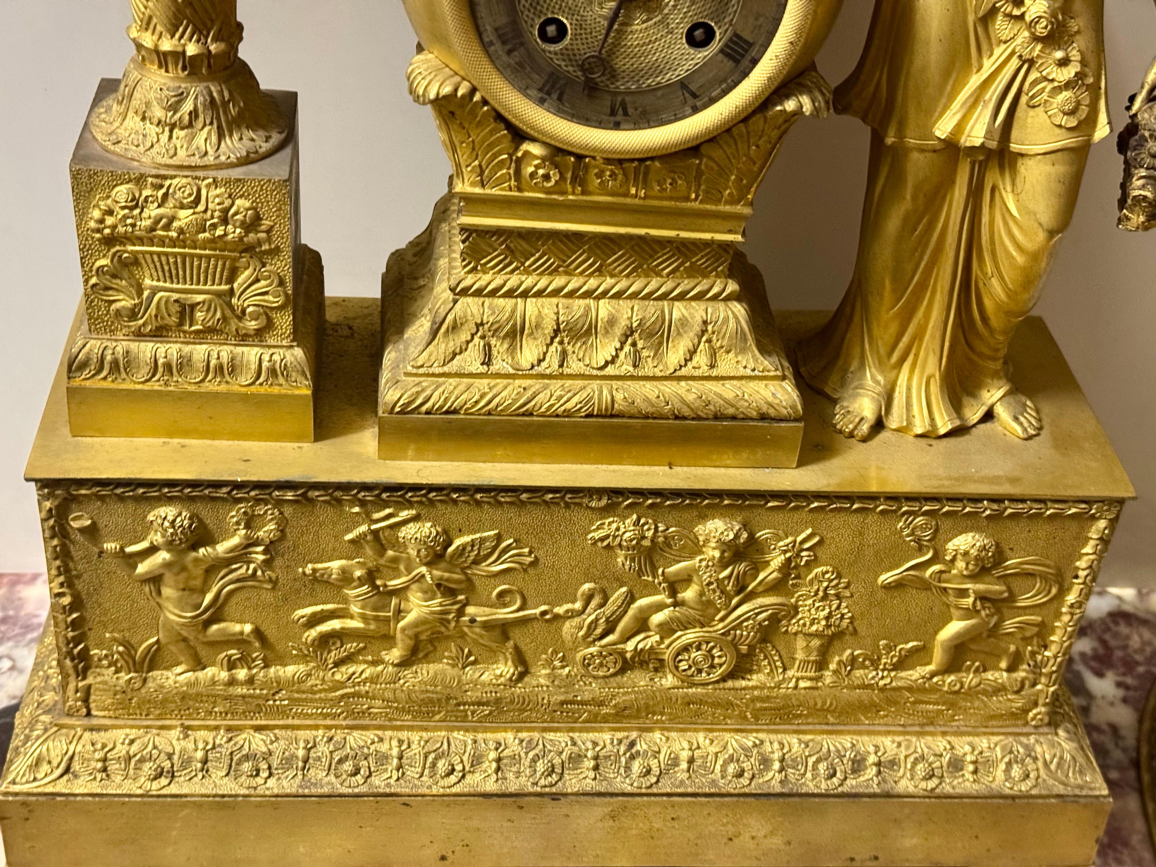 Magnificent empire clock in its original gilding , one of the most beautiful models
executed at this time.The beauty of this woman standing ,the base decorated with children
one of whom is sitting on a horse pulling a chariot decorated wiyh swans ,