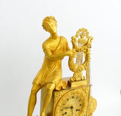 EMPIRE CLOCK in bronze with its beautiful original gilded patina depicting