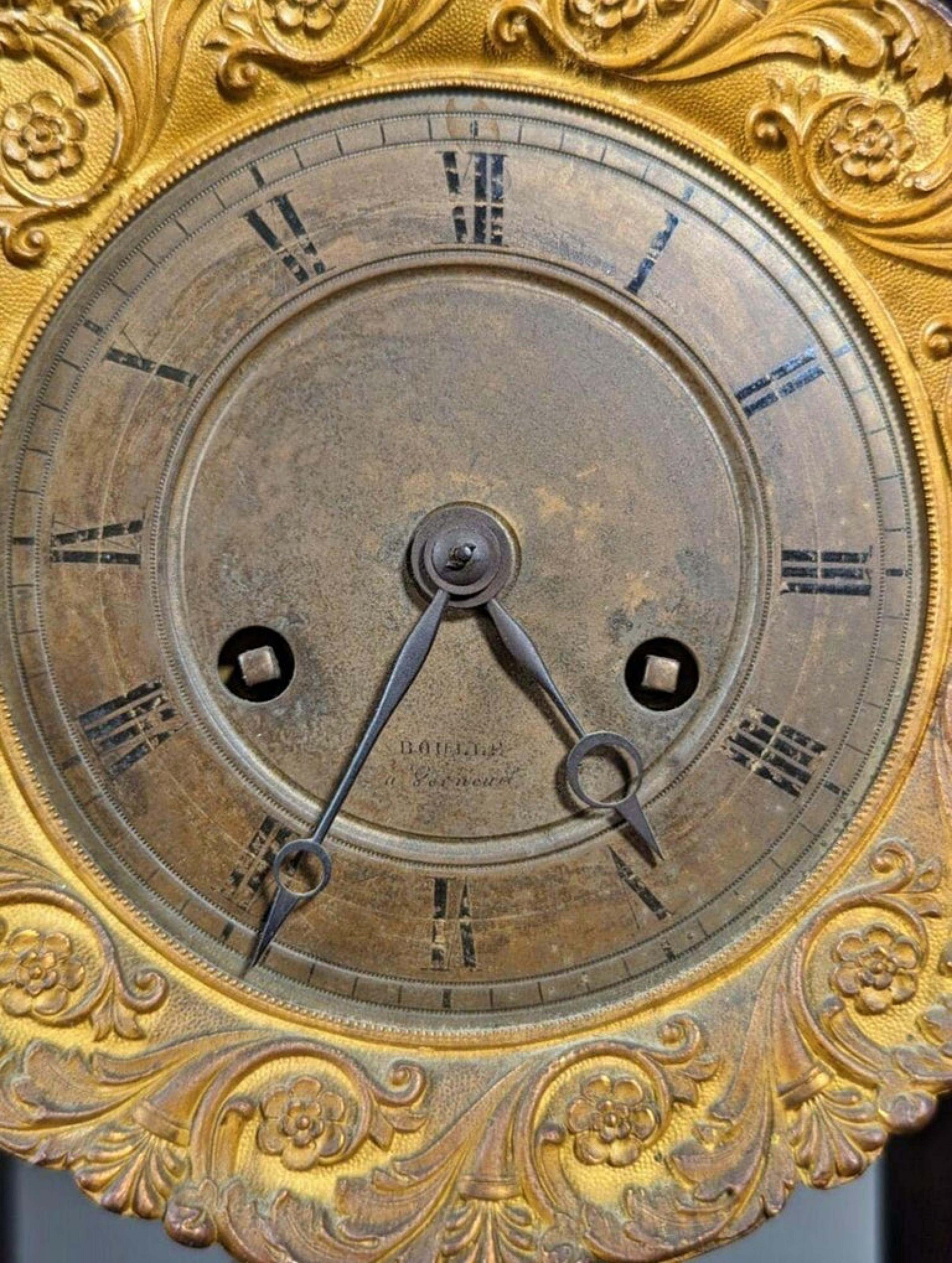 Empire Clock Napoleon III 19th Century
in blackened wood, ormolu and stamped brass, circular bronze dial with Arabic numerals signed 