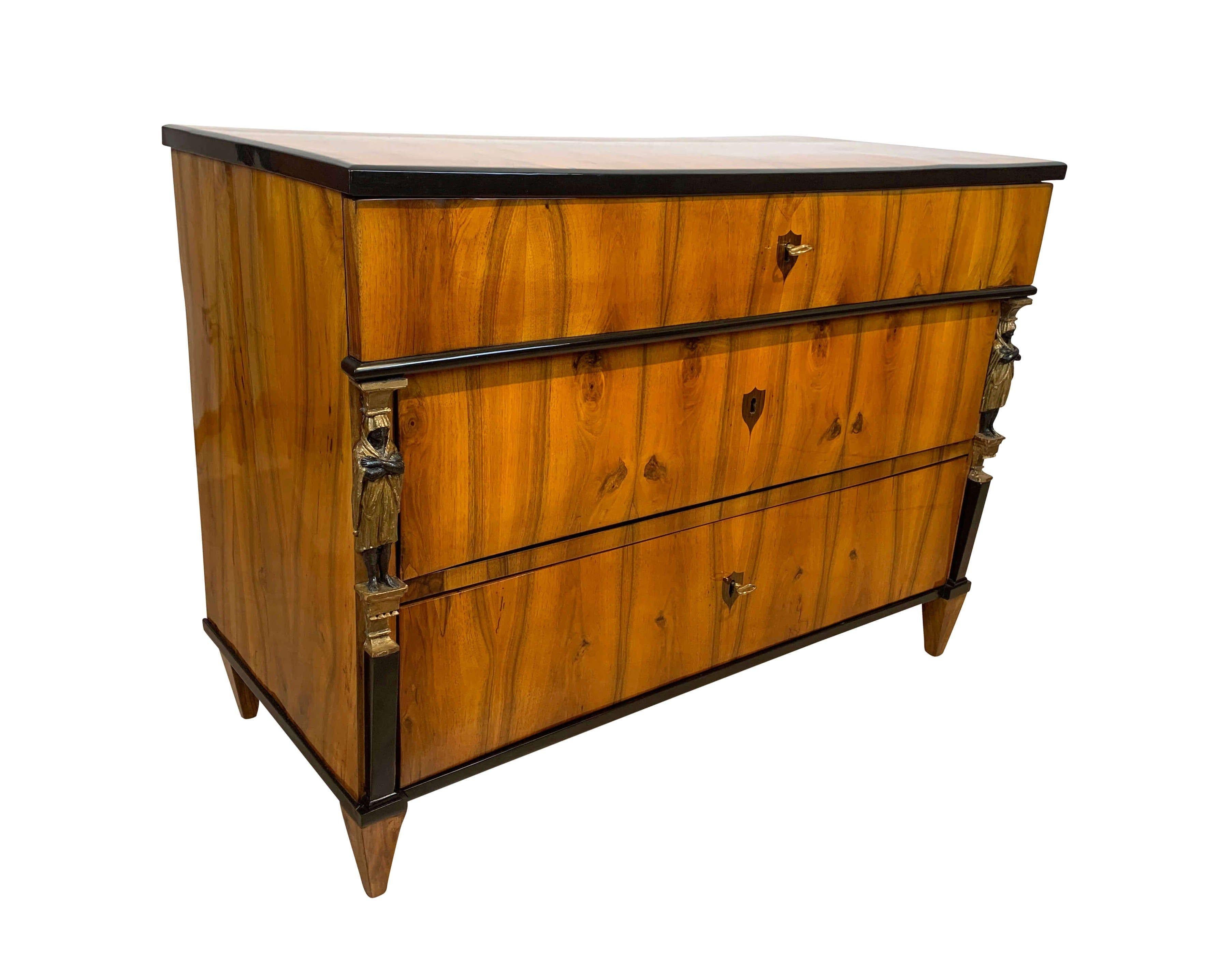 Very fine original Empire commode or chest of three drawers, walnut veneered with Caryatid pilaster columns, from Austria/Vienna about 1810-15.
 
Lovely book-matched Walnut Veneer on softwood. Excellent french polished surface.
Exceptional carved