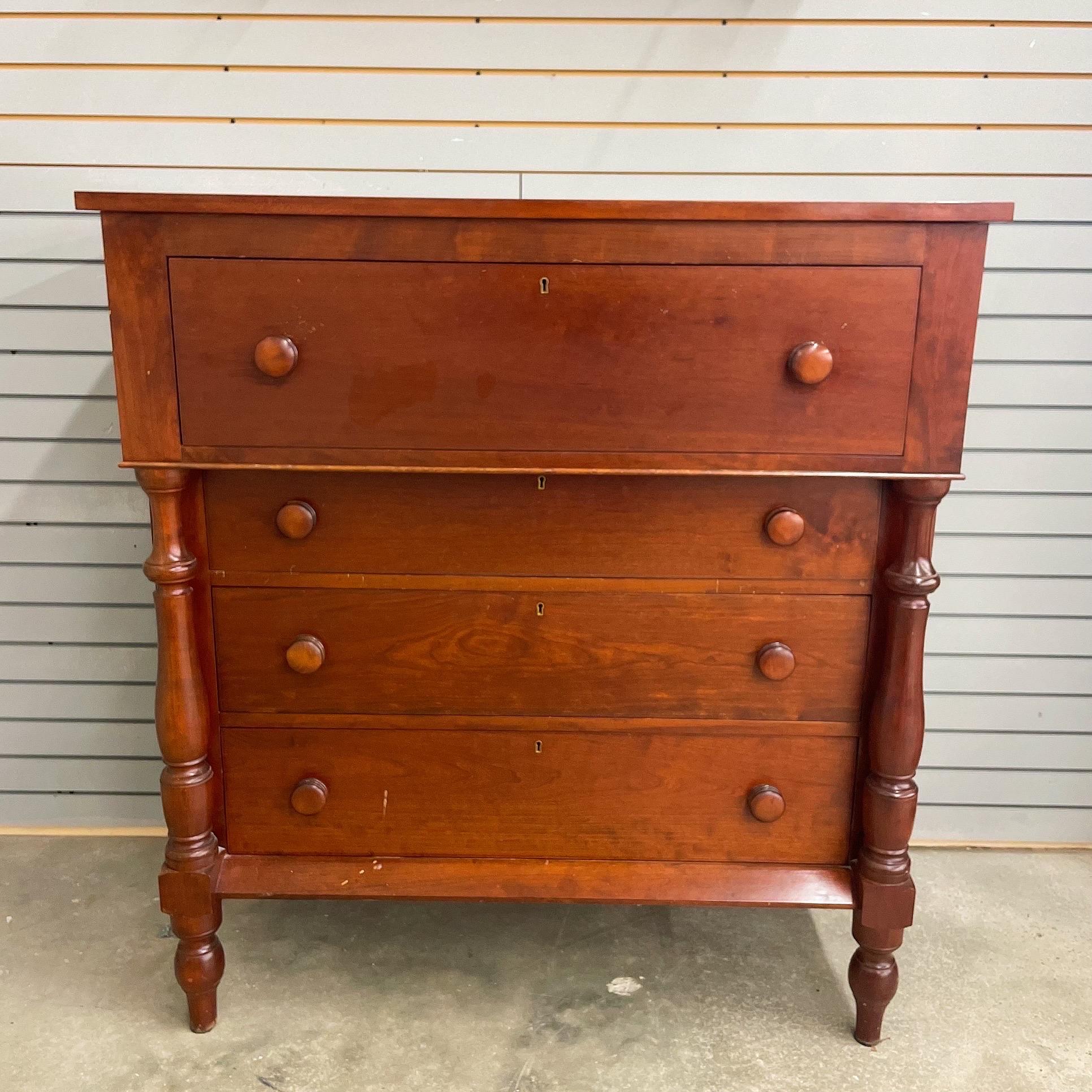 Beautifully crafted Empire style solid cherry wood chest of drawers. Dovetail joints, turned legs and drawer pulls. Amazing aged patina. In classic empire style, the top drawer is the largest and deepest. Highly carved posts on the dresser and 4