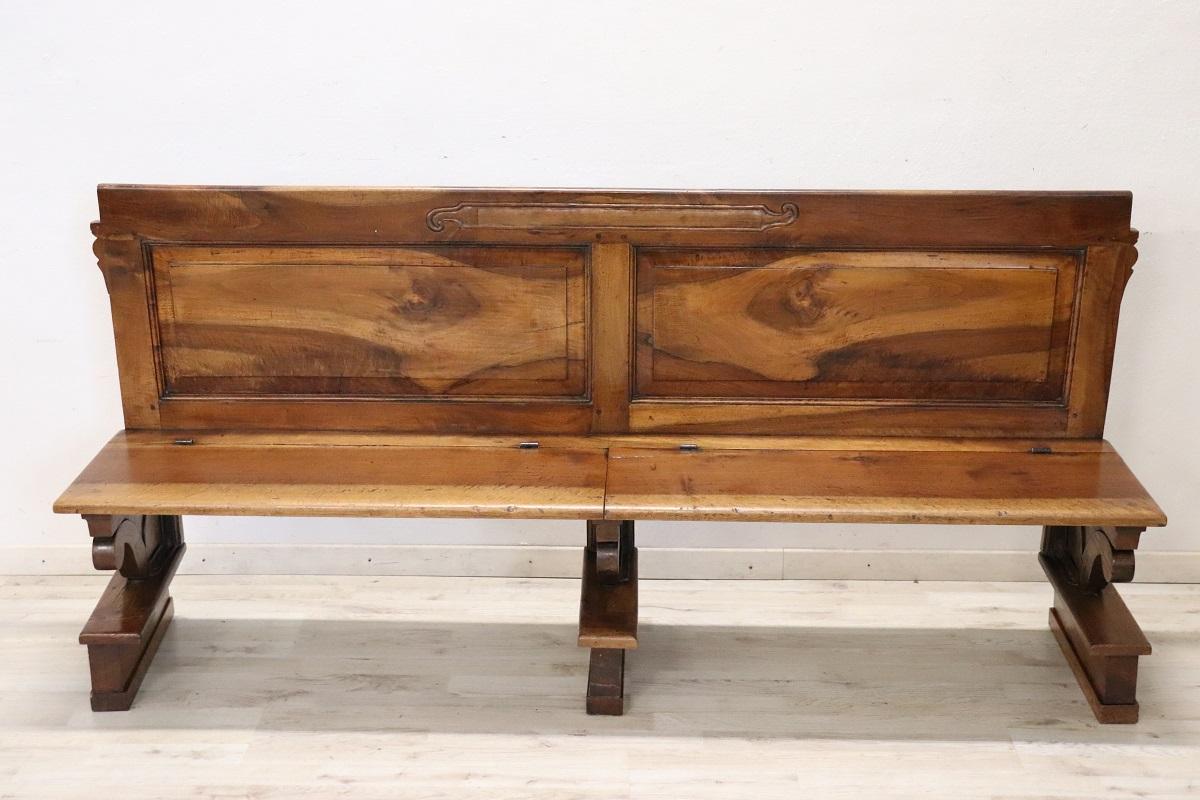 Antique Italian empire bench early 19th century. The bench is made of solid walnut wood. Excellent antique good conditions of the wood. Characterized by a seat with folding panels.