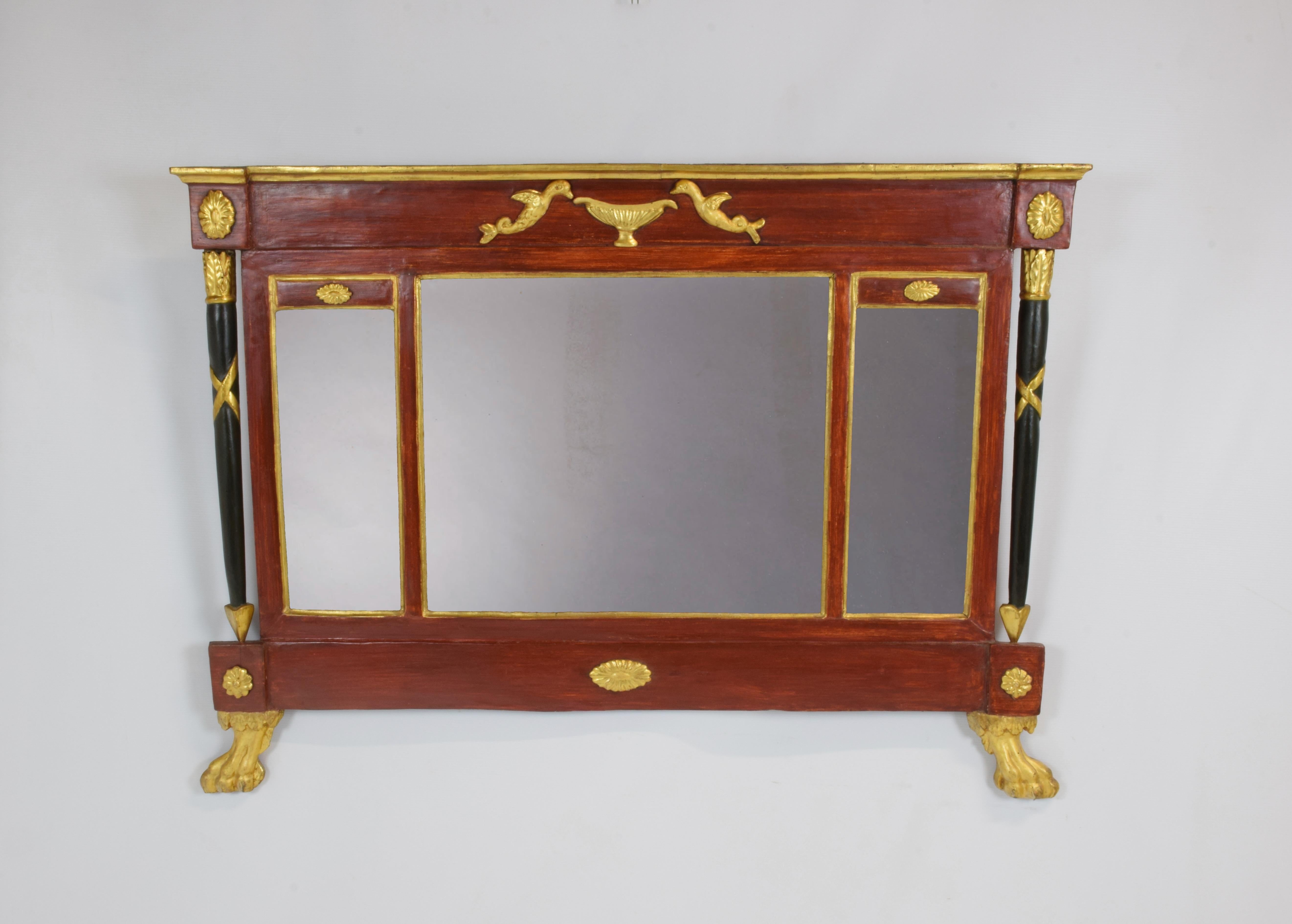 Rectangular mirror born to be placed on the fireplace. The mirror is divided into three original parts separated by frames with a golden border. Original the color that recalls the famous Pompeian red. On the sides two black arrow-shaped columns