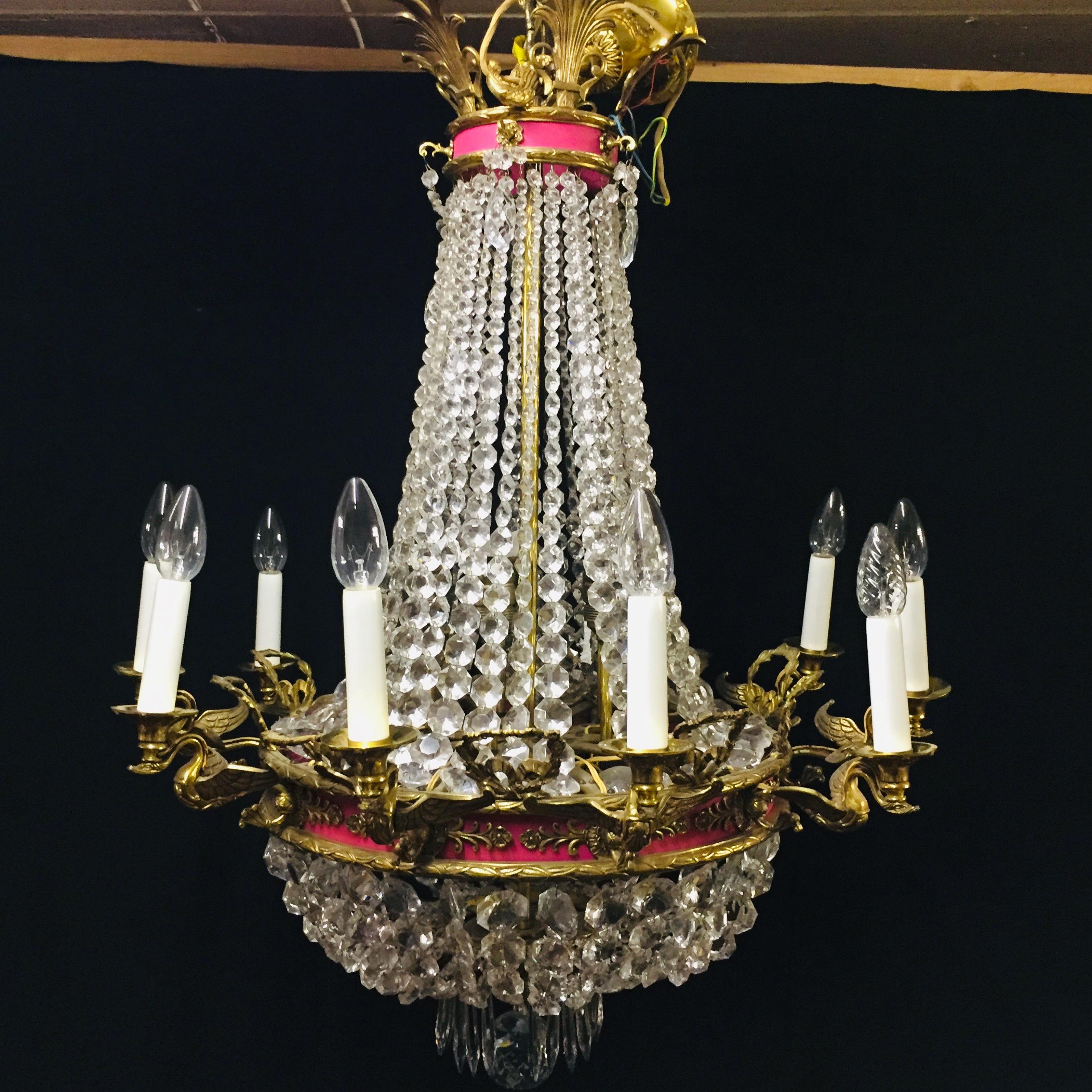 A fine French Empire swan chandelier featuring 10 branches of finely cast gilded brass shaped as swans
crystal and brass basket chandelier with 10 brass swan arms, 10 lamps inside.
The large and small ring is decorated with fittings, the bottom