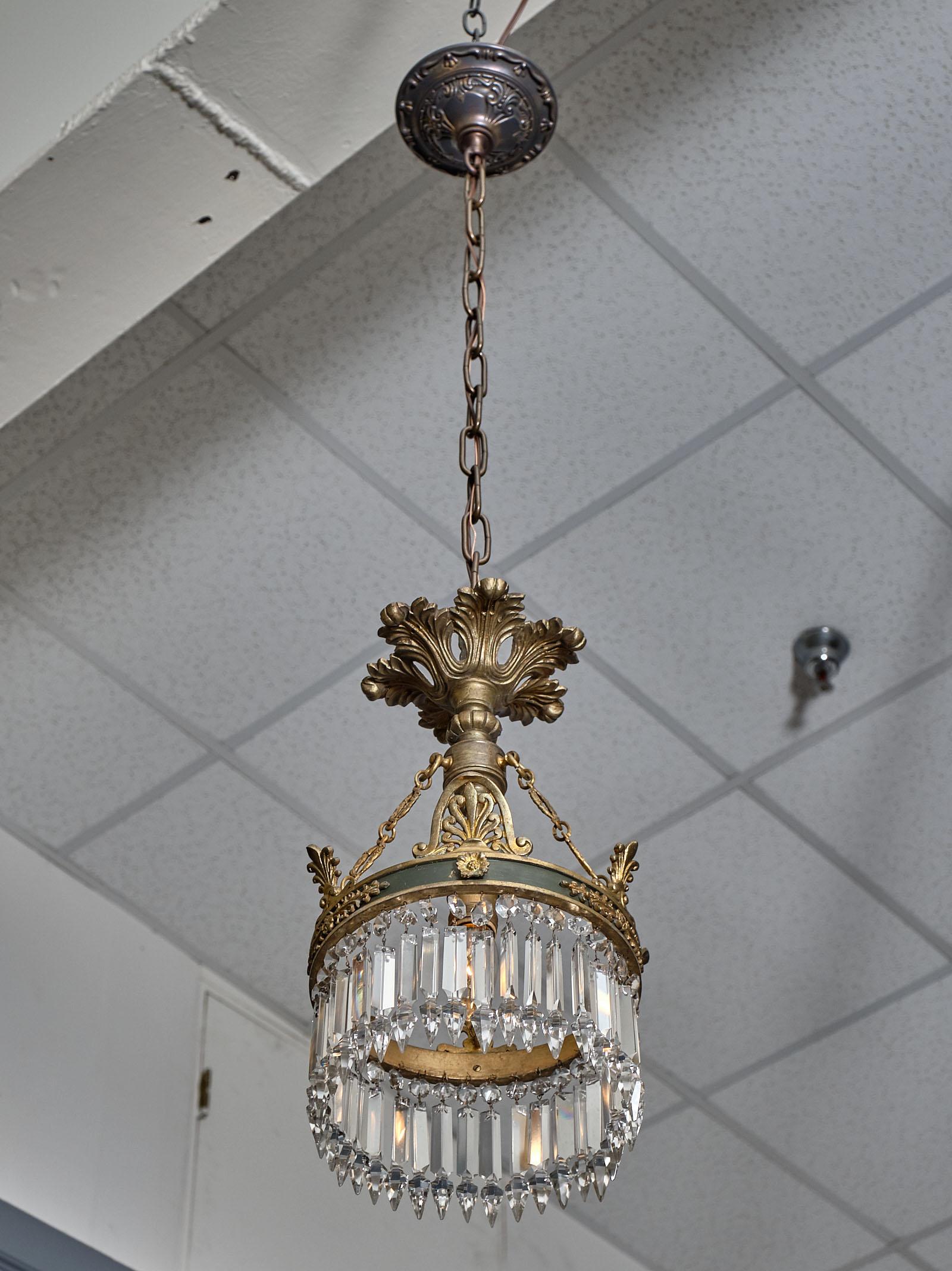 Empire French crystal chandelier pendant made of gilt bronze and lacquer. There are lovely finely cut crystal and the chandelier has been newly wired to fit US standards.