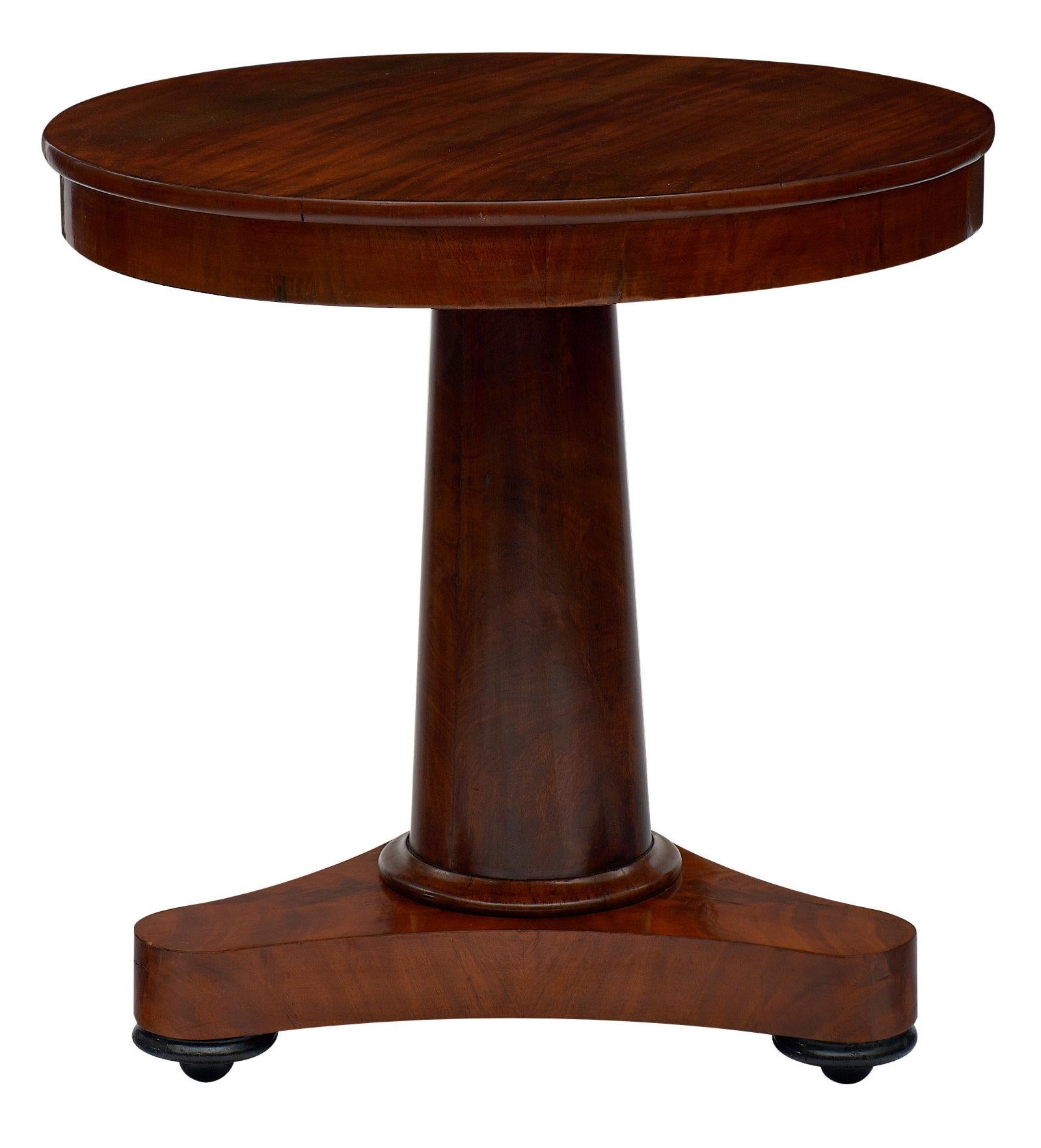 French Empire guéridon made of Cuban flamed mahogany and featuring a central tripod foot. We loved the bold lines and neoclassical proportions. There is a versatile feel of the piece with beautiful warmth to the wood.