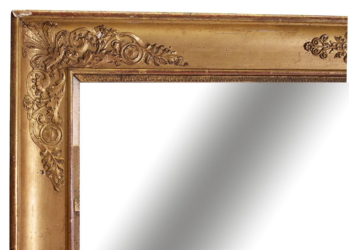 This French 19th Century large-scale Empire Gold Gilt mirror is a large statement piece. The neoclassical embossed motif is a classic French form. Original backing. We believe this to be the original gilding, it has not been restored in the US.