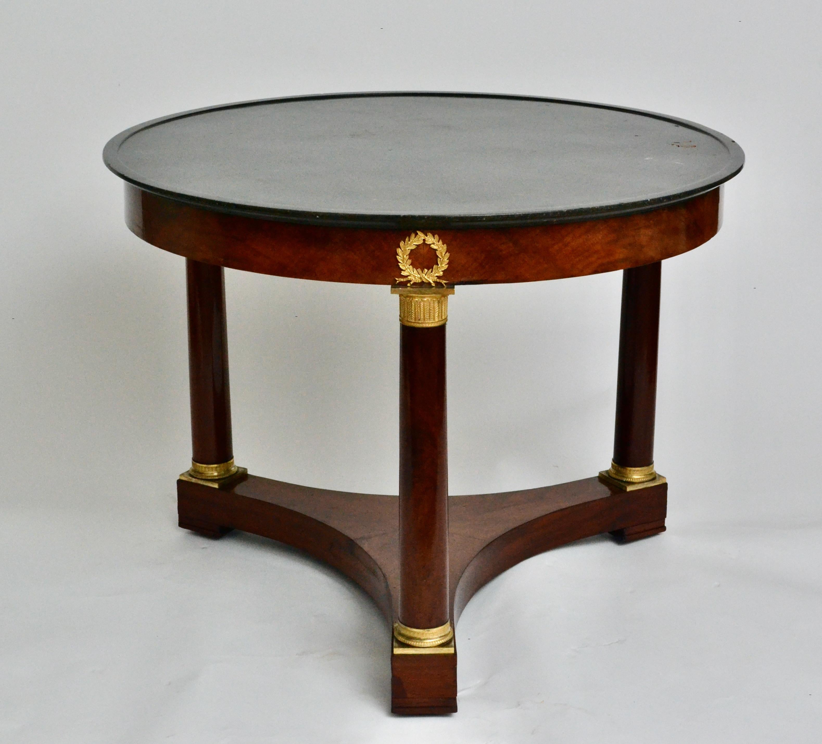 French Empire Gueridon or Center Table With Black Marble Top With Gilt Bronze Mounts.