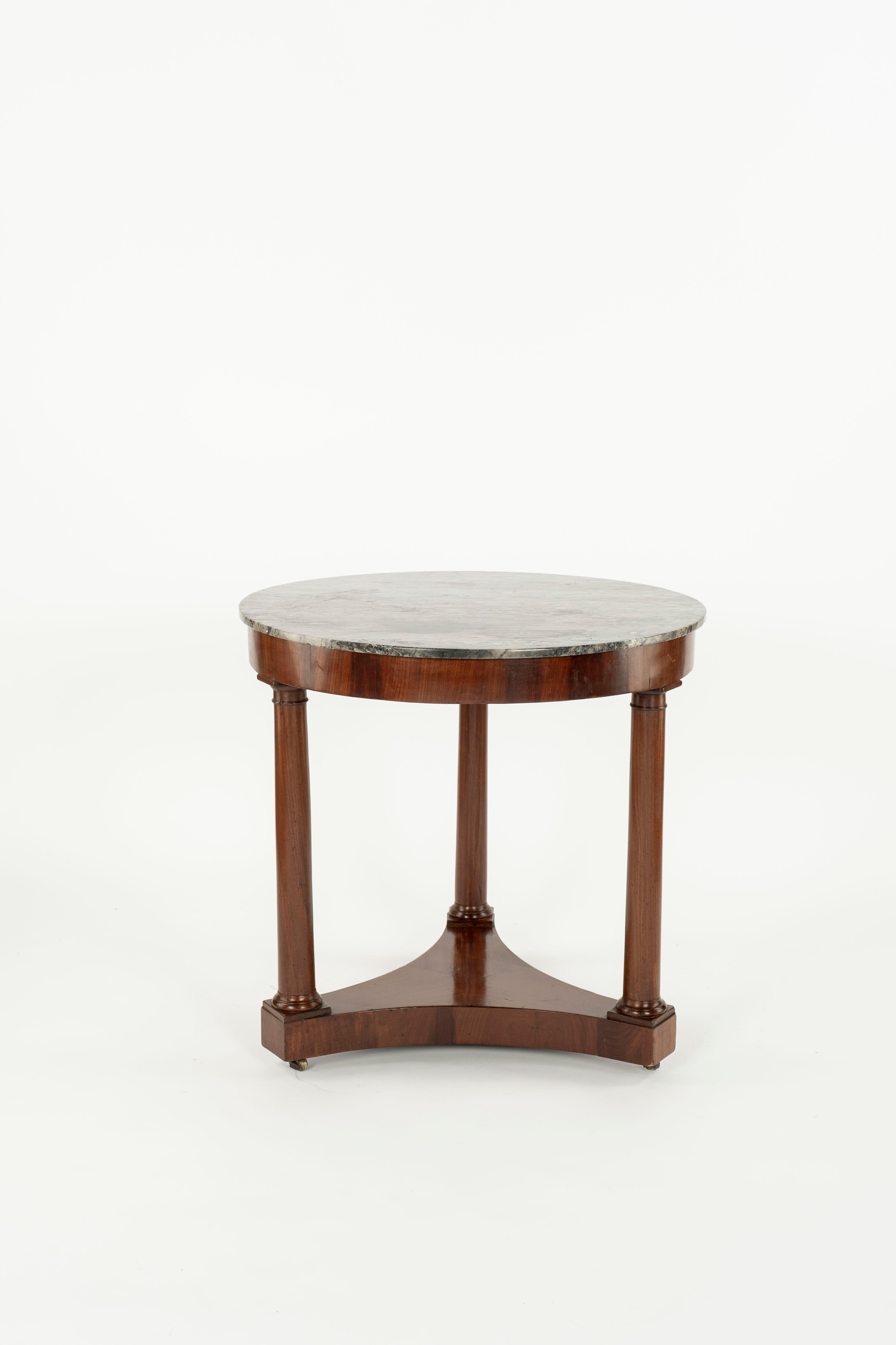 A small classic mahogany gueridon. Three mahogany legs united by a flat platform base. The grey marble top is the original. Superb colour with rich patina. France Circa 1860.