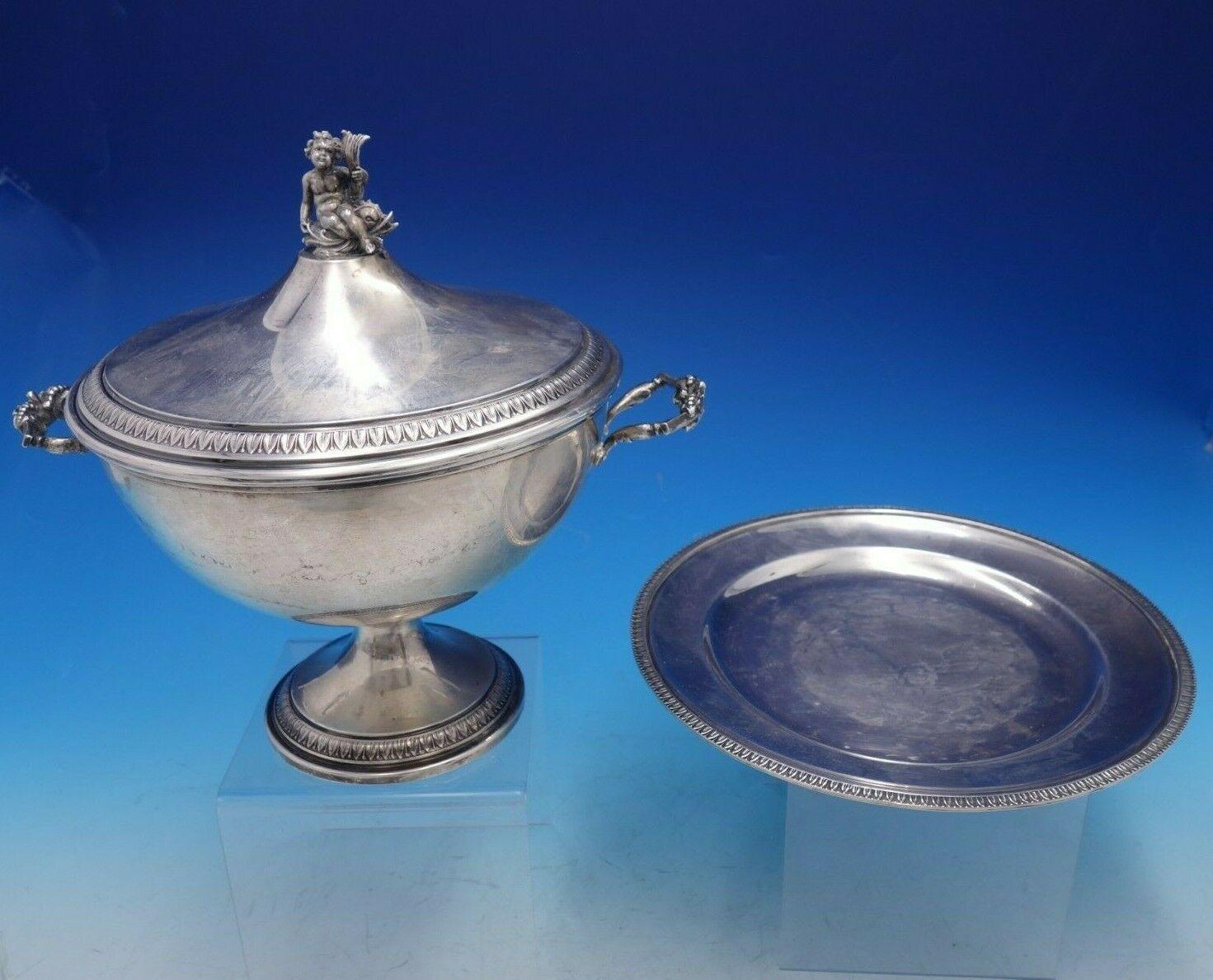Italian silver

Fabulous vintage figural Empire Italian 800 silver soup tureen with underplate. The tureen with figural finial depicting a cherub sitting atop a dolphin measures 10 3/4