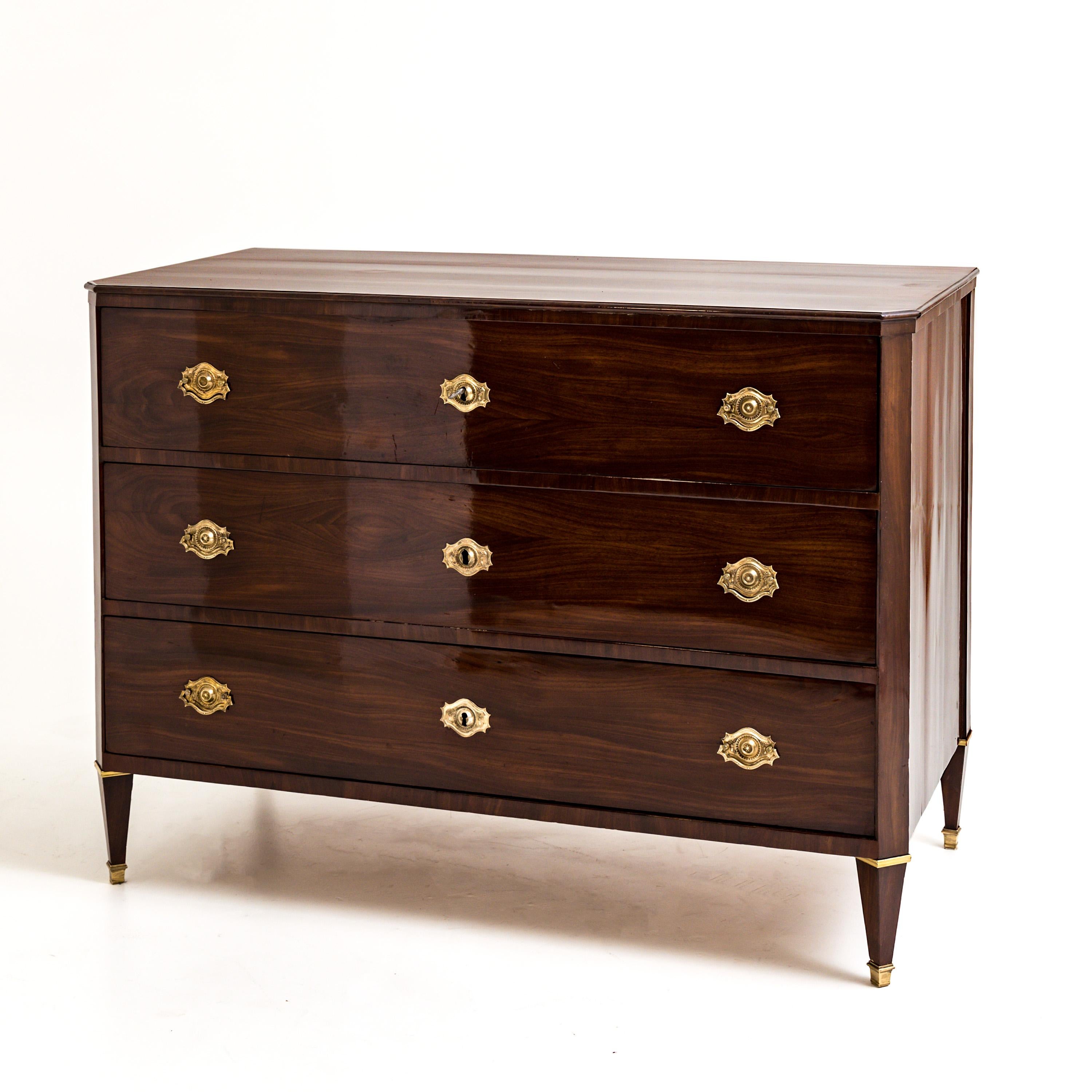 Three-drawer mahogany chest of drawers standing on square-pointed legs with bevelled corners and fire-gilded bronze fittings. The chest of drawers was expertly refurbished and hand polished.