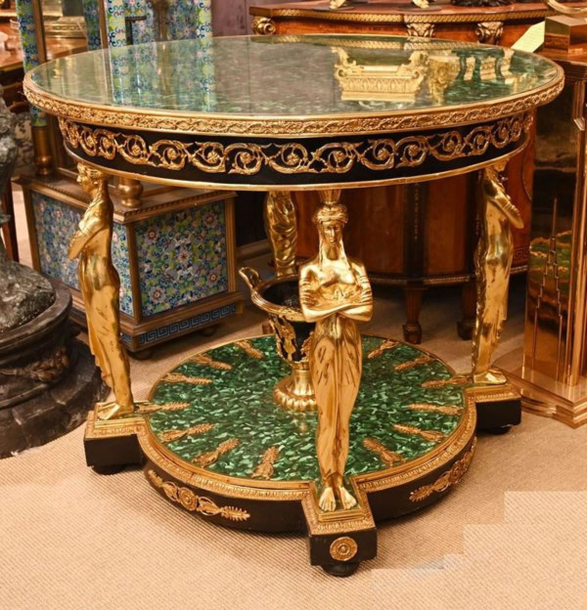Stunning French Empire table in gilt with malachite base and top
Such a great look to this piece which reeks of style and elegance
The look is very high Empire with all the classical and Greek references
Of course the four table legs are gilt