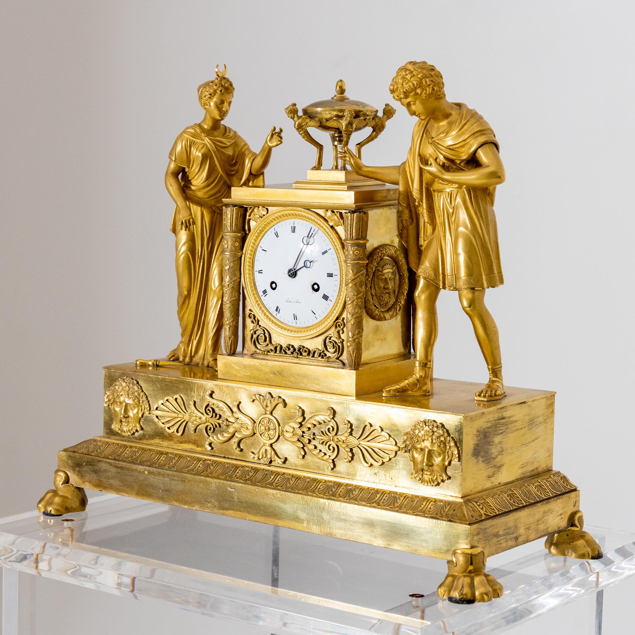 Fire-gilt mantle clock on lion paw feet with full-figure depictions of Diana and Apollo. Signed Roux à Paris on the enamel dial.
