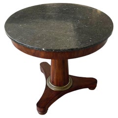 Mesa redonda con pedestal Empire de mármol y caoba