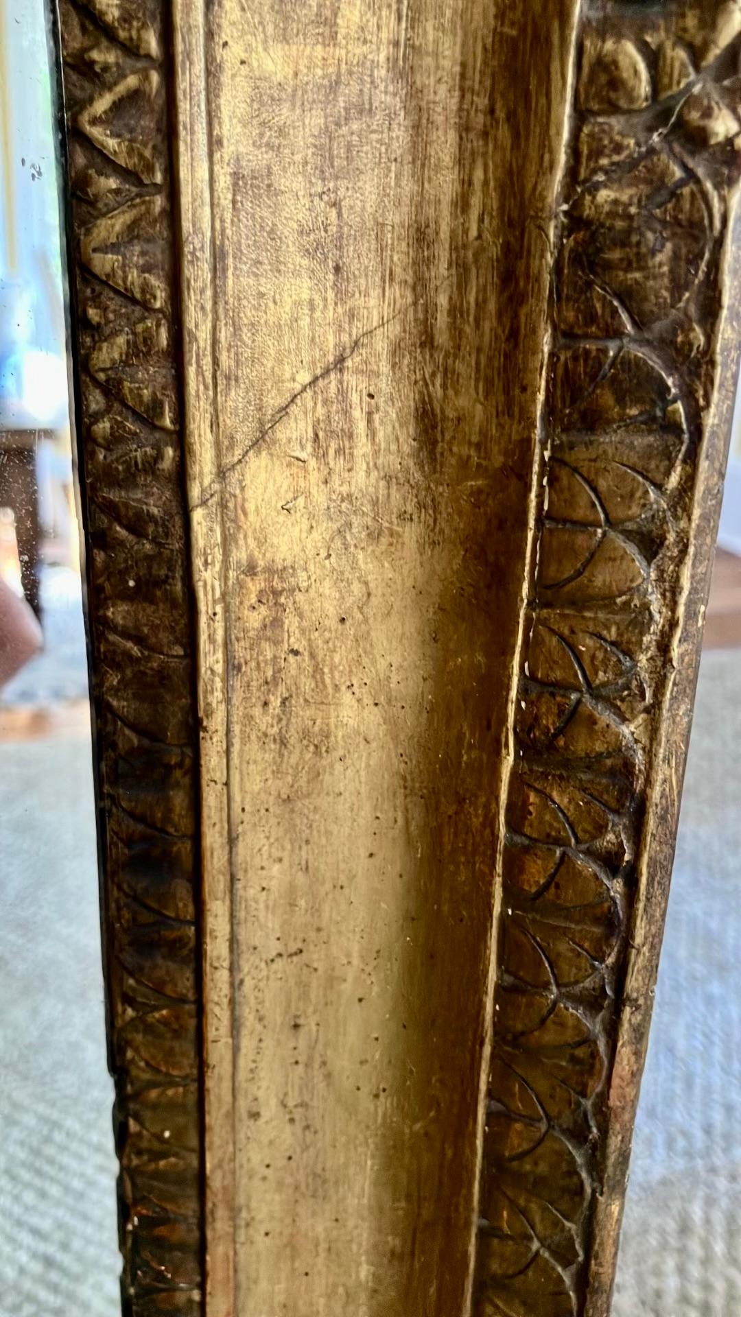 Empire Neoclassical gilt mirror. Antique Italian gilt Neoclassical mirror frame with interior leaf and dart holding with large ogee band and outer acanthus leaf and dart moulding with later vintage mirror plate. Italy circa 1800's
Dimensions: 31