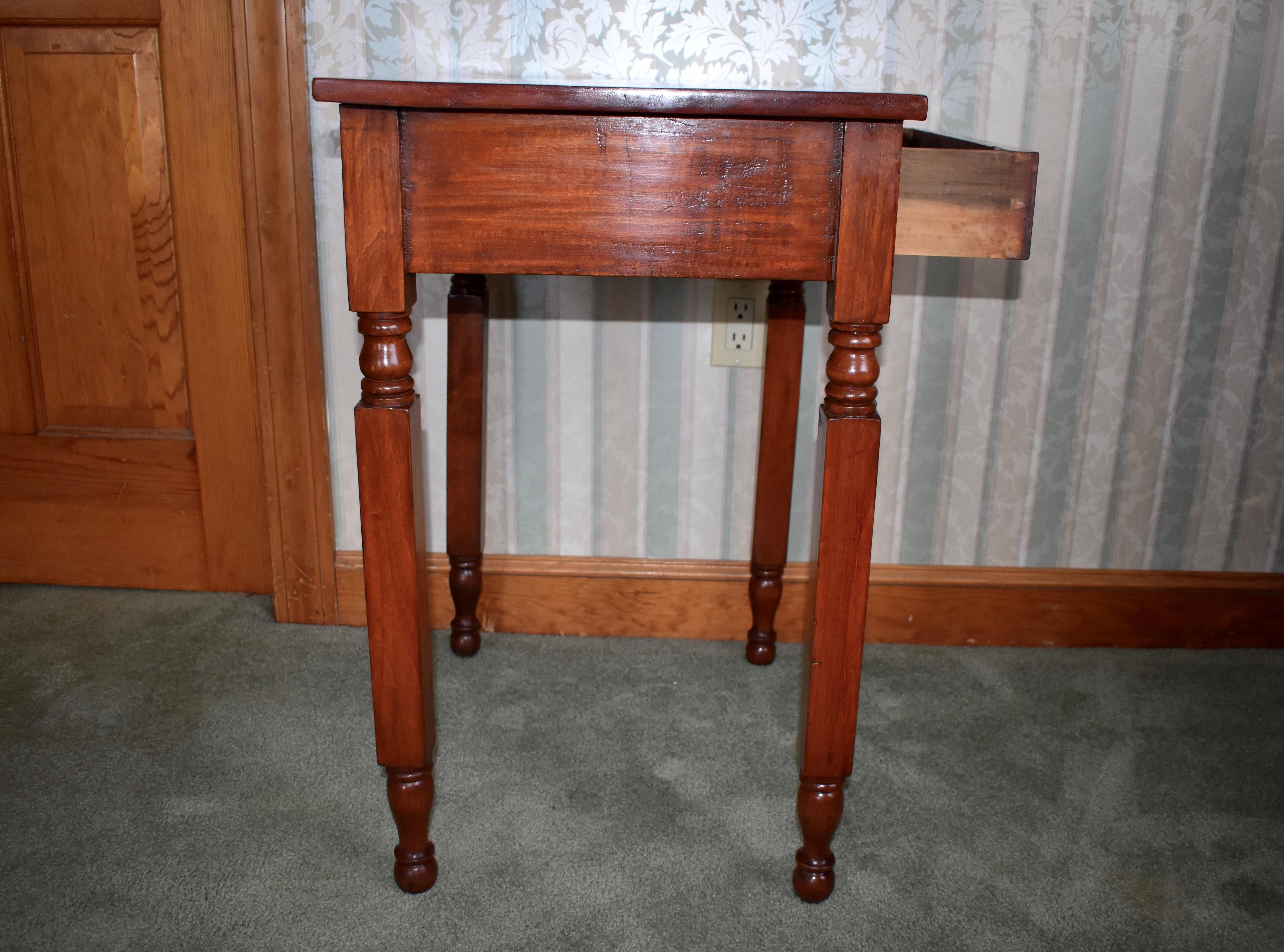 Empire one drawer stand in cherry and pine, circa 1820 Upstate, NY. Very nice condition. Top recently refinished to match. Knob original to piece. Measures: 28.5