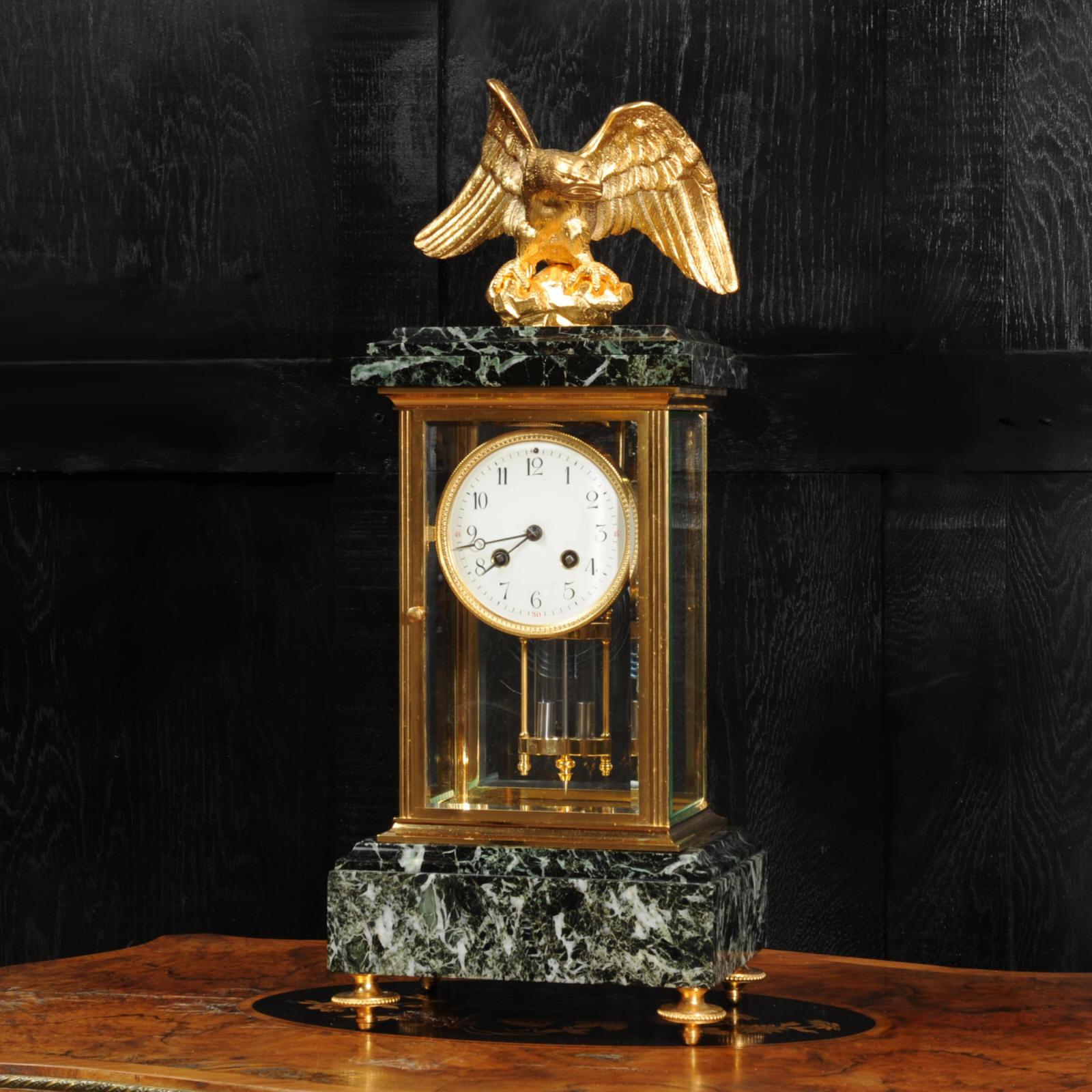 A stunning original antique French clock by the illustrious maker Charles Hour, circa 1890. It is of the beautifully restrained Empire design in a sumptuous green variegated specimen marble and ormolu (finely gilded bronze). To the top is a