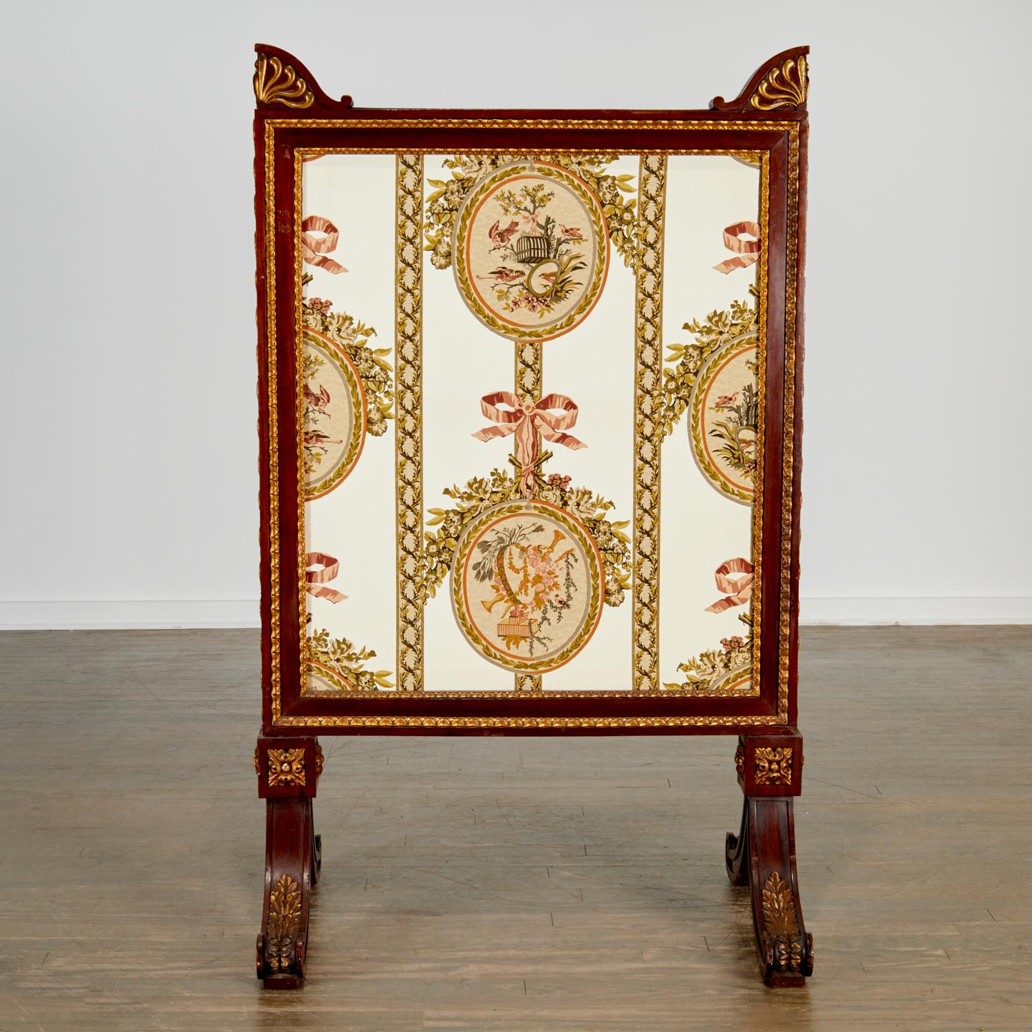 19th c., France. Substantial double sided fire screen. A mahogany rectangular frame is relief carved with parcel gilt bellflower borders and sides. The screen has a double sided printed fabric panel depicting birds and flowers in pinks, golds and
