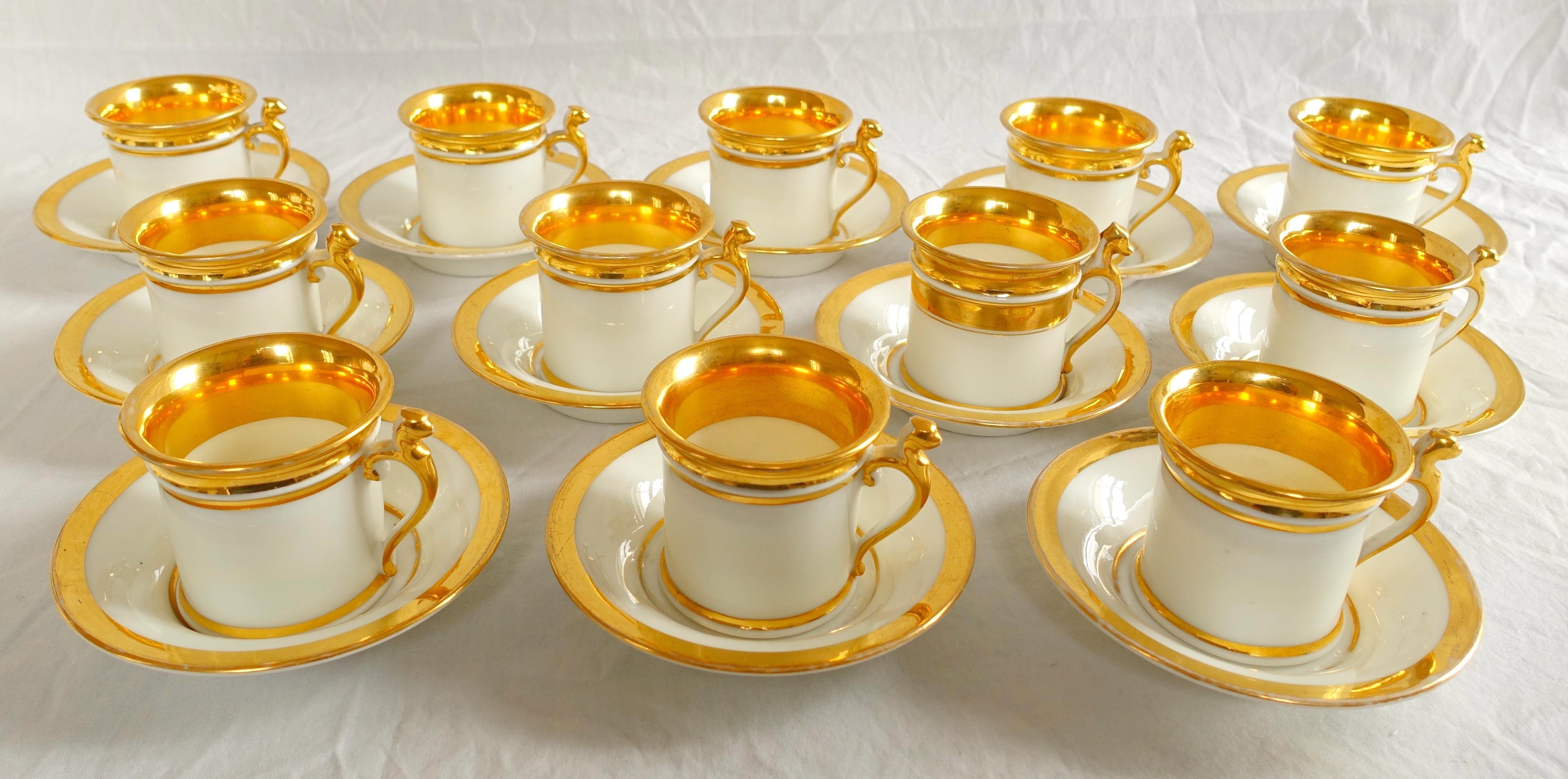 Set of 12 Paris porcelain so-called litron coffee cups (cylindrical shaped cups, more sought-after) and their saucer ; it is a beautiful early 19th century fine work circa 1830 (Restauration period) enhanced with large fine gold gilt strips on a