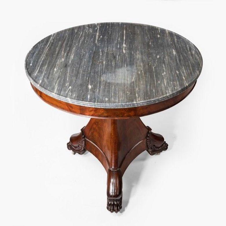 Empire period mahogany guéridon or center table with marble top. 
 
