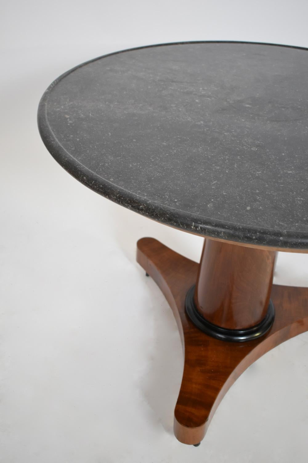 Table ronde à piédestal en acajou et placage d'acajou, table d'appoint, table de salle à manger, table à thé, fût de colonne, plateau en granit noir avec vasque, époque Empire. France, C.I.C.