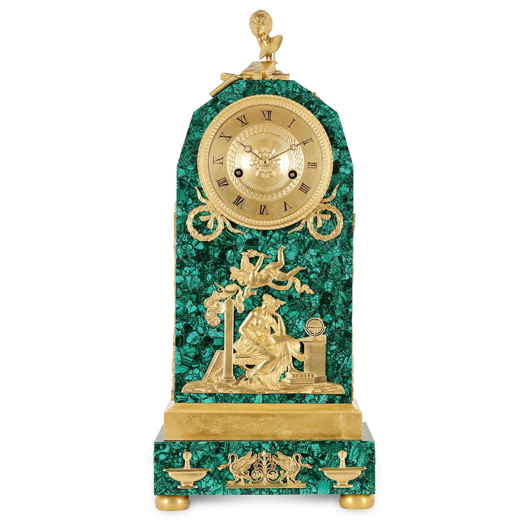 Empire period ormolu mounted malachite allegorical mantel clock
French, early 19th century
Measures: Height 50m, width 21cm, depth 14cm

This fine mantel clock is an excellent example of Empire period design. The Empire period is defined by a