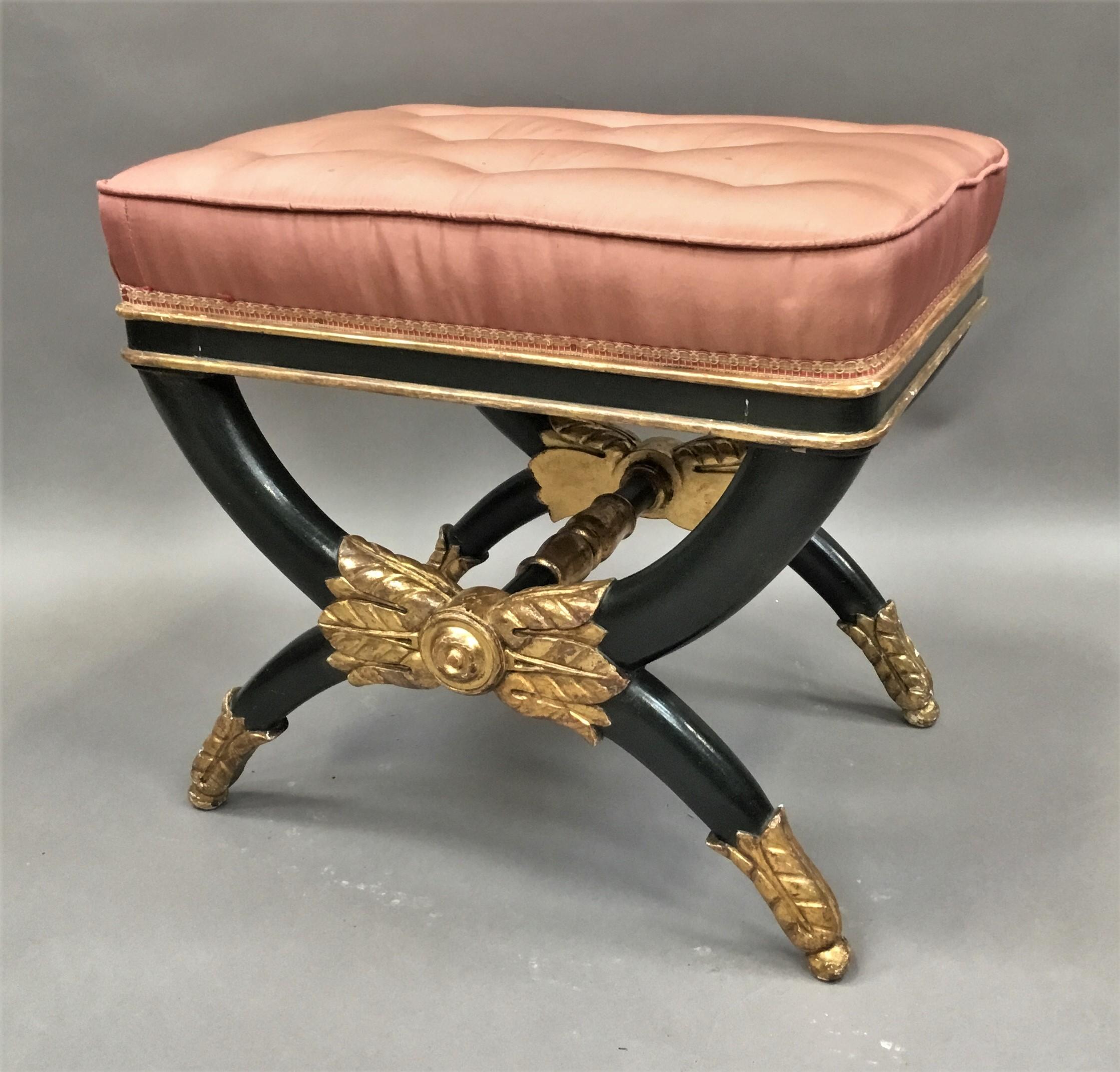 Good Regency /Empire 'X' frame stool, decorated with parcel gilt and dark green to simulate bronze; the rectangular padded buttoned seat upholstered in pink silk on the shallow seat frame, with rounded corners and gilt mouldings top and bottom.